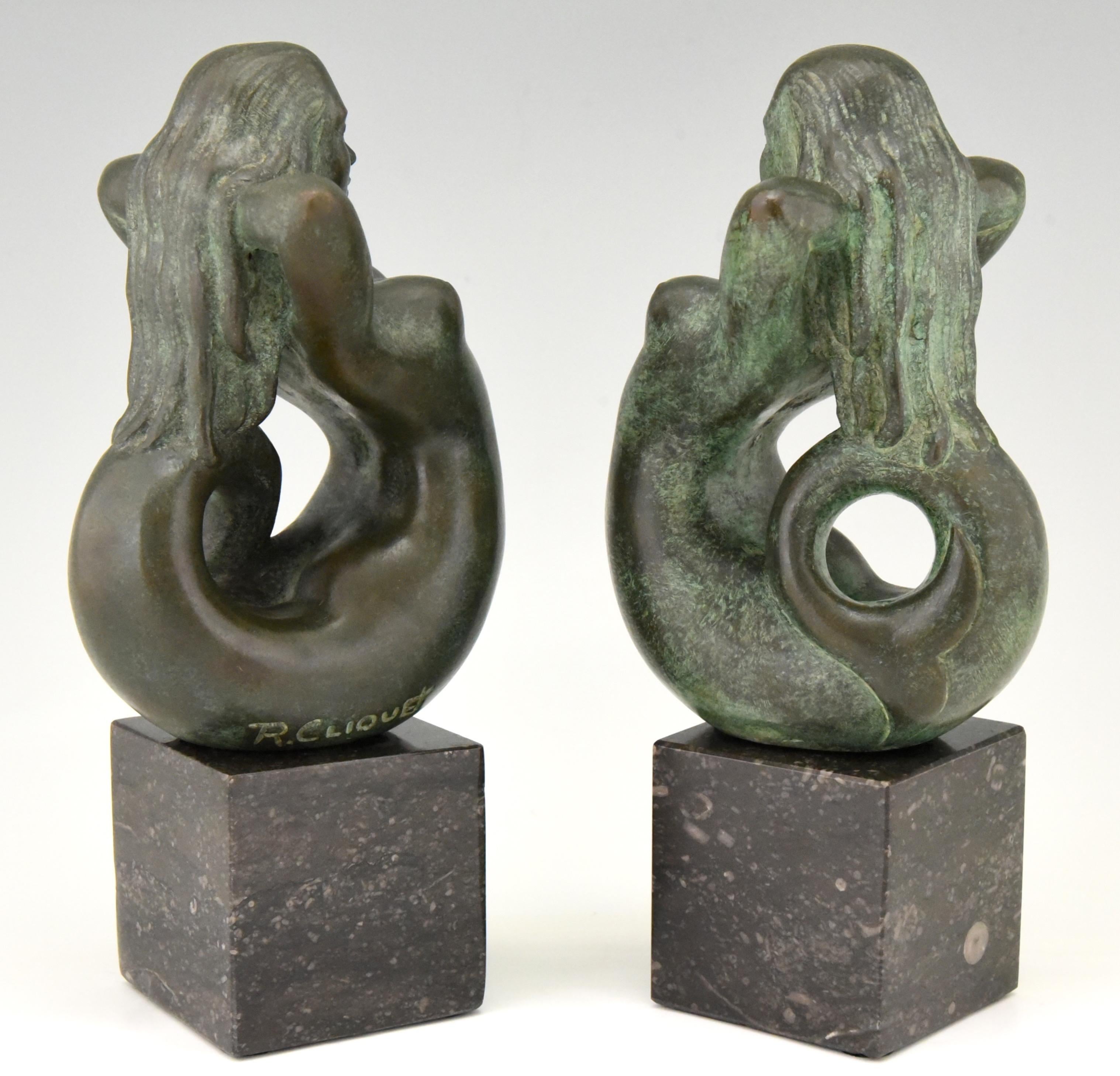 Lovely pair of midcentury bronze mermaid bookends 
Signed by the Belgian artist Rene Cliquet, 1899-1974
The bronze figures are mounted on marble bases. 

 