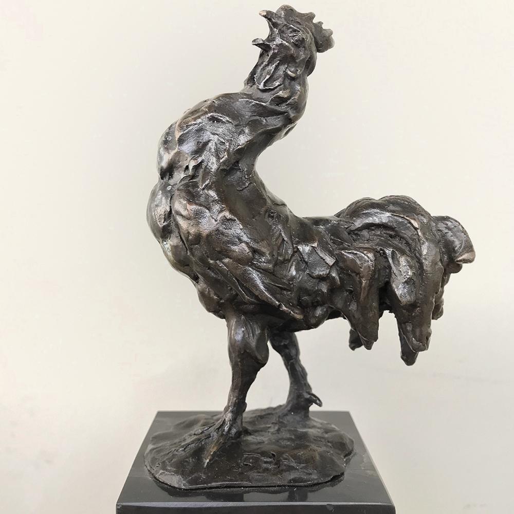 Midcentury bronze statue of rooster depicts a cock crowing to announce the dawn. Hand-sculpted and given a patinaed finish, it is a splendid reminder of the historical symbolism of the strutting bird. The association between the rooster and the