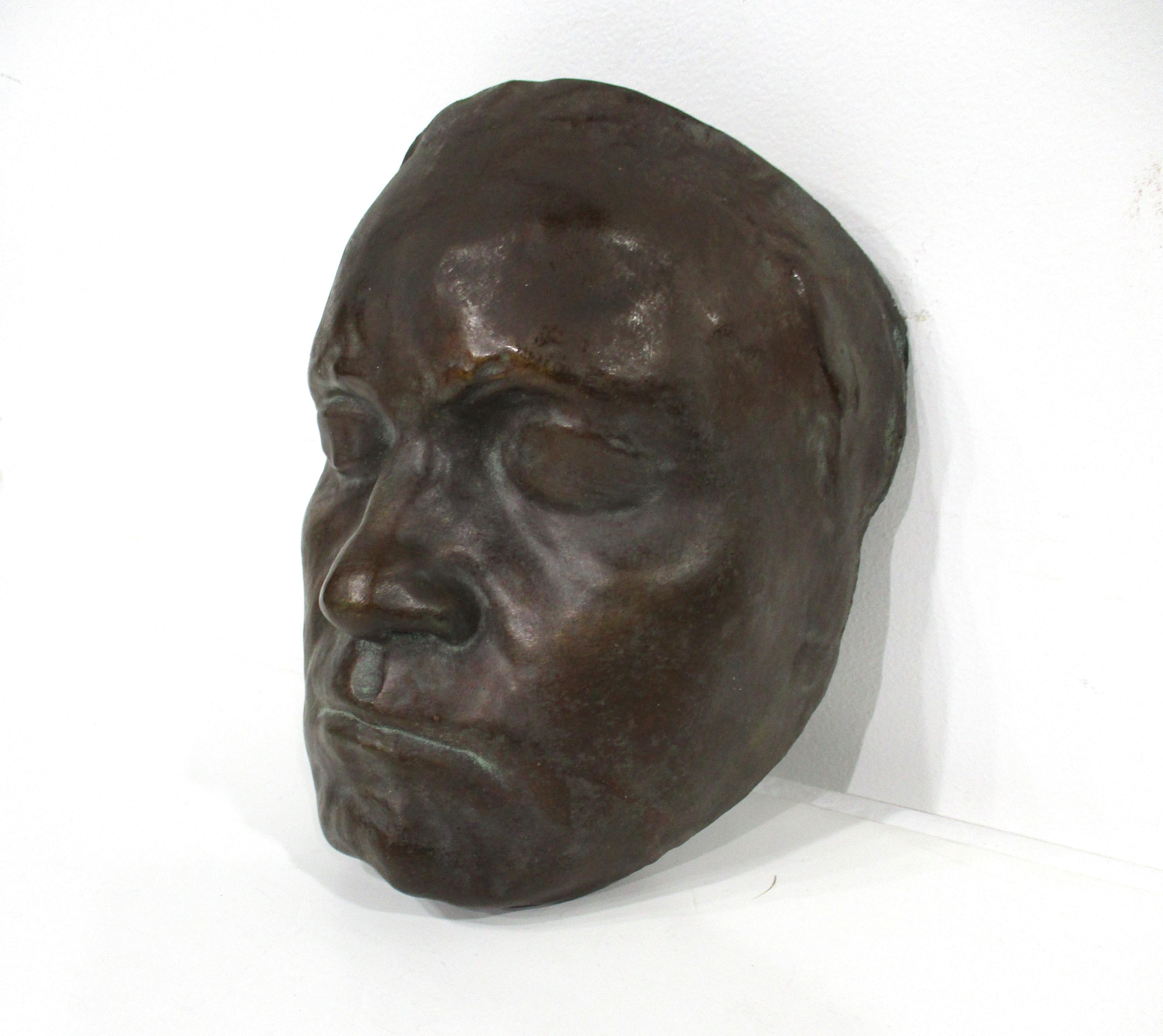 A plaster cast mask with great strong details of a male face with a pottery styled glaze in the manner of bronze which is very realistic . This could be a so called death mask which was popular in the early 1900's to the later 1940's having a molded