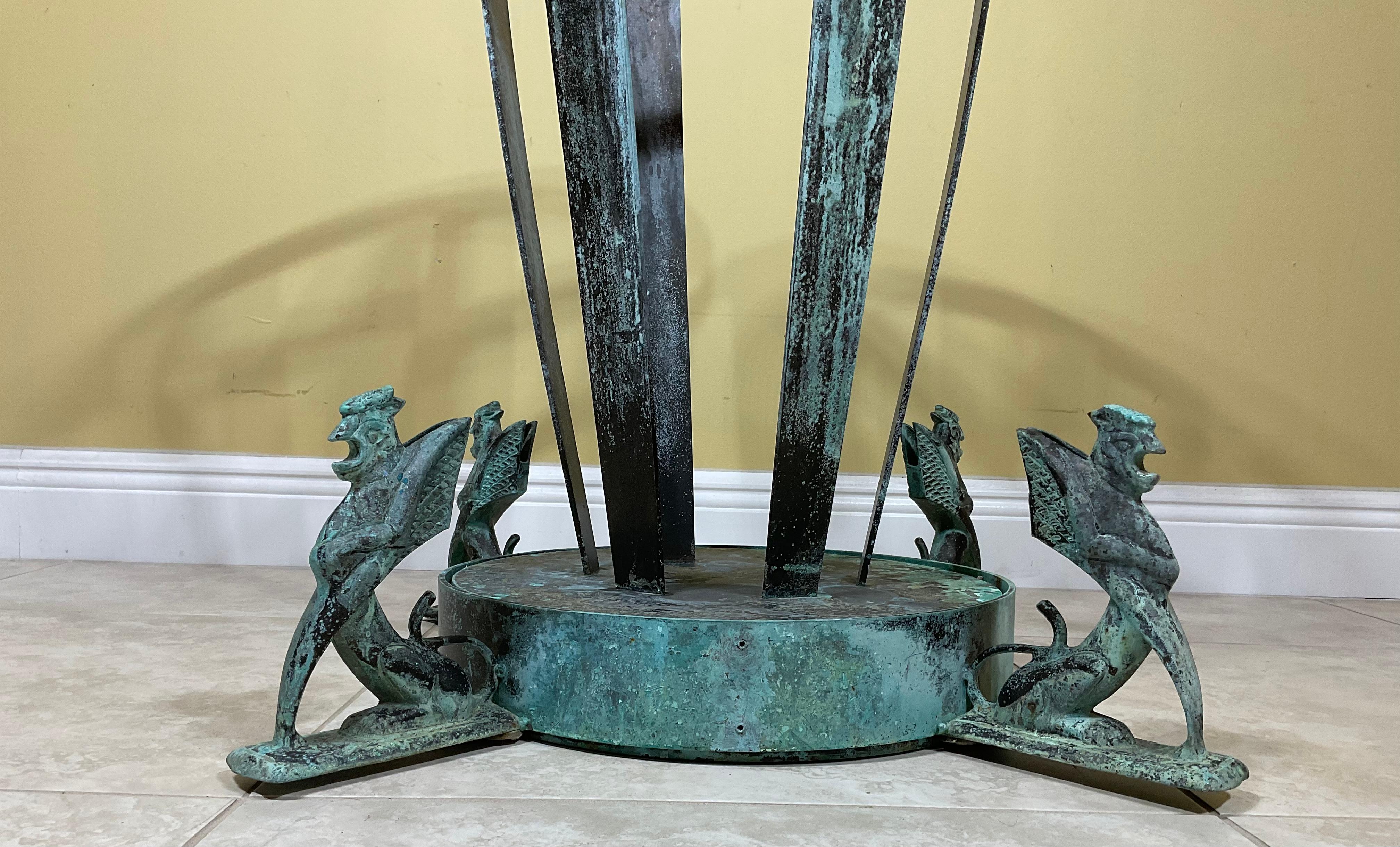 Beautiful table base made of solid bronze and brass, round top with Diameter of 16”.decorative bottom base with four sides with Phoenix bird style on each corner. Weathered oxidise green-turquoise color patina.
Exceptional object of art for display.