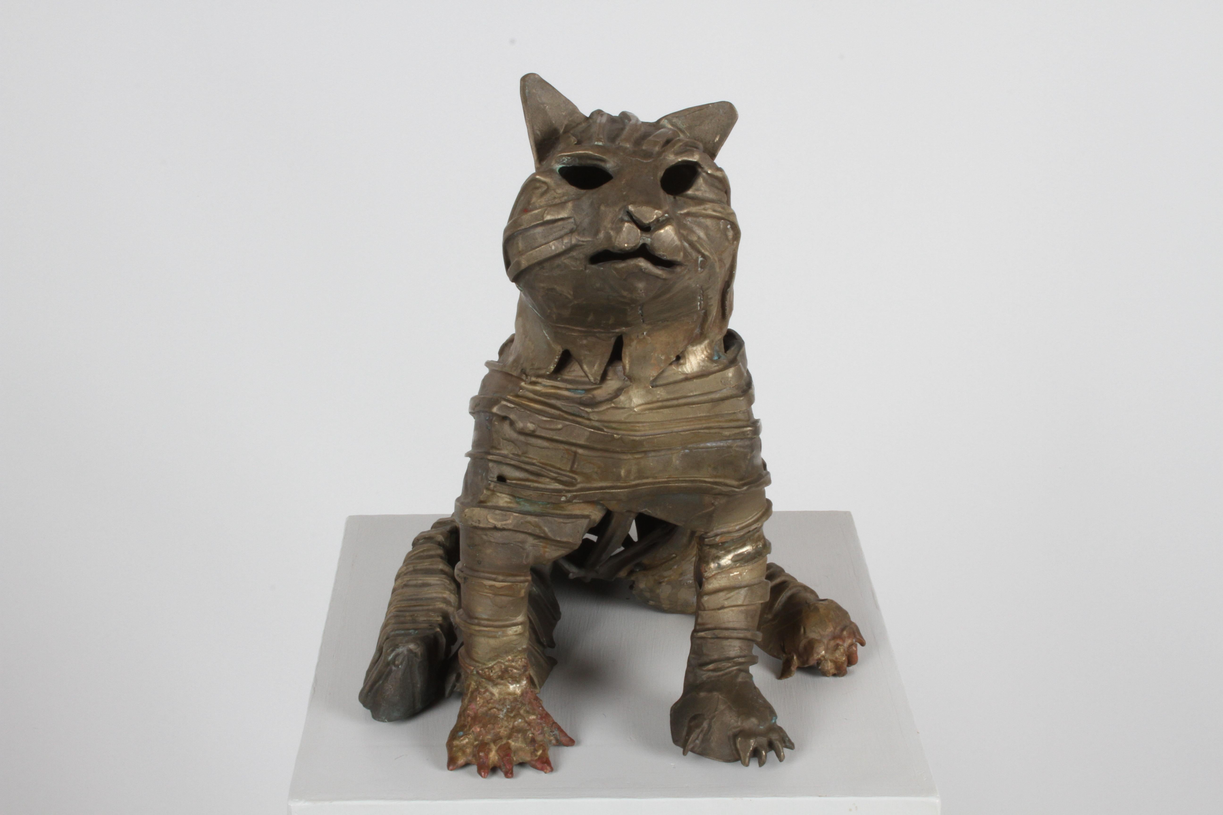 Unique cast and welded bronze brutalist sculpture of a cat in the style of a mummy. Having cast bronze gause wrapping around body with welded detail to front paw, in the style of British artist Jane Ackroyd (born 1957). Unsigned.