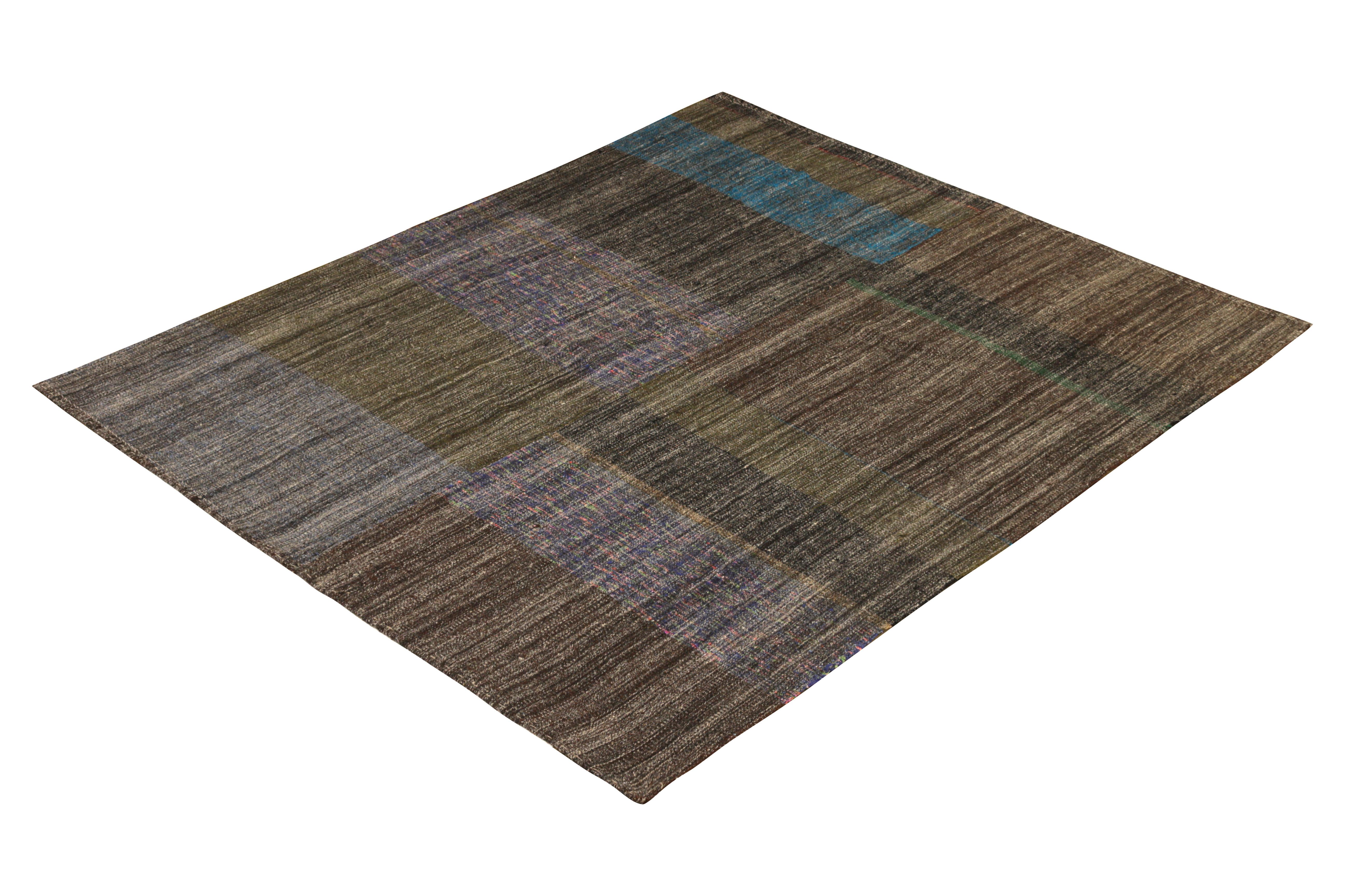 Handmade in a wool flat-weave originating from Turkey circa 1950-1960, this item is a midcentury vintage Kilim rug woven in a distinctive paneled style, remarking the bisection of pattern in the center and the intriguing colorway variations it