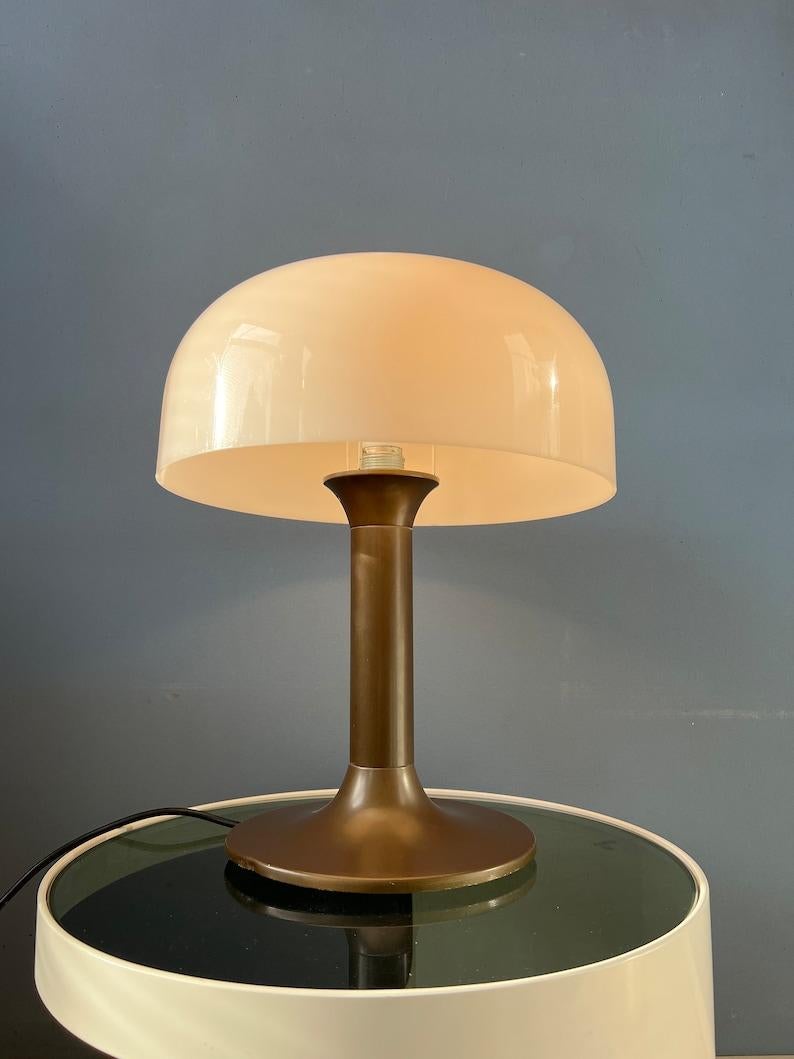 Big space age mushroom table lamp with large white shade and metal base. The acrylic glass mushroom shade produces a nice and warm light. The lamp requires one E27/26 (standard) lightbulb and currently has an EU-plug (can easily be used outside EU