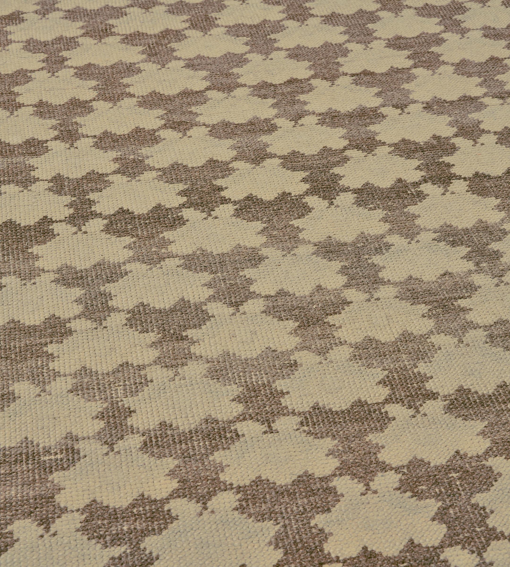 This mid-century Turkish rug has a mole-brown field with diagonal rows of buff-brown bold floral motifs, in a narrow buff-brown and pale aubergine linked lozenge border between plain outer stripes.

Vintage Turkish rugs showcase a blend of