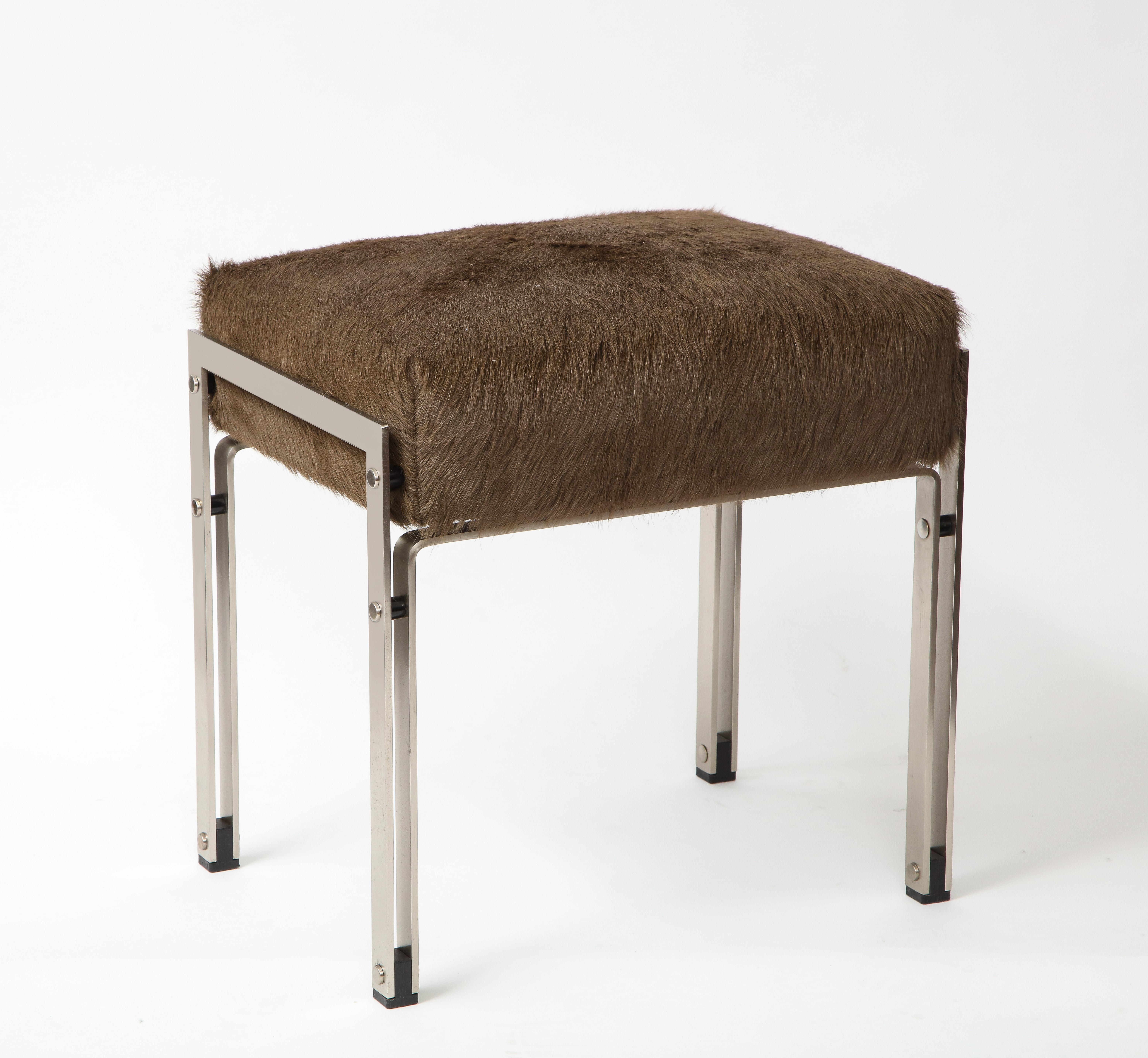 Mid-century chrome upholstered stool, 20th century. 

This stool consists of sleek, flat-edge chrome legs as well as a comfortable seat that has been newly recovered in a plush brown hair-on-hide.

Excellent vintage condition.