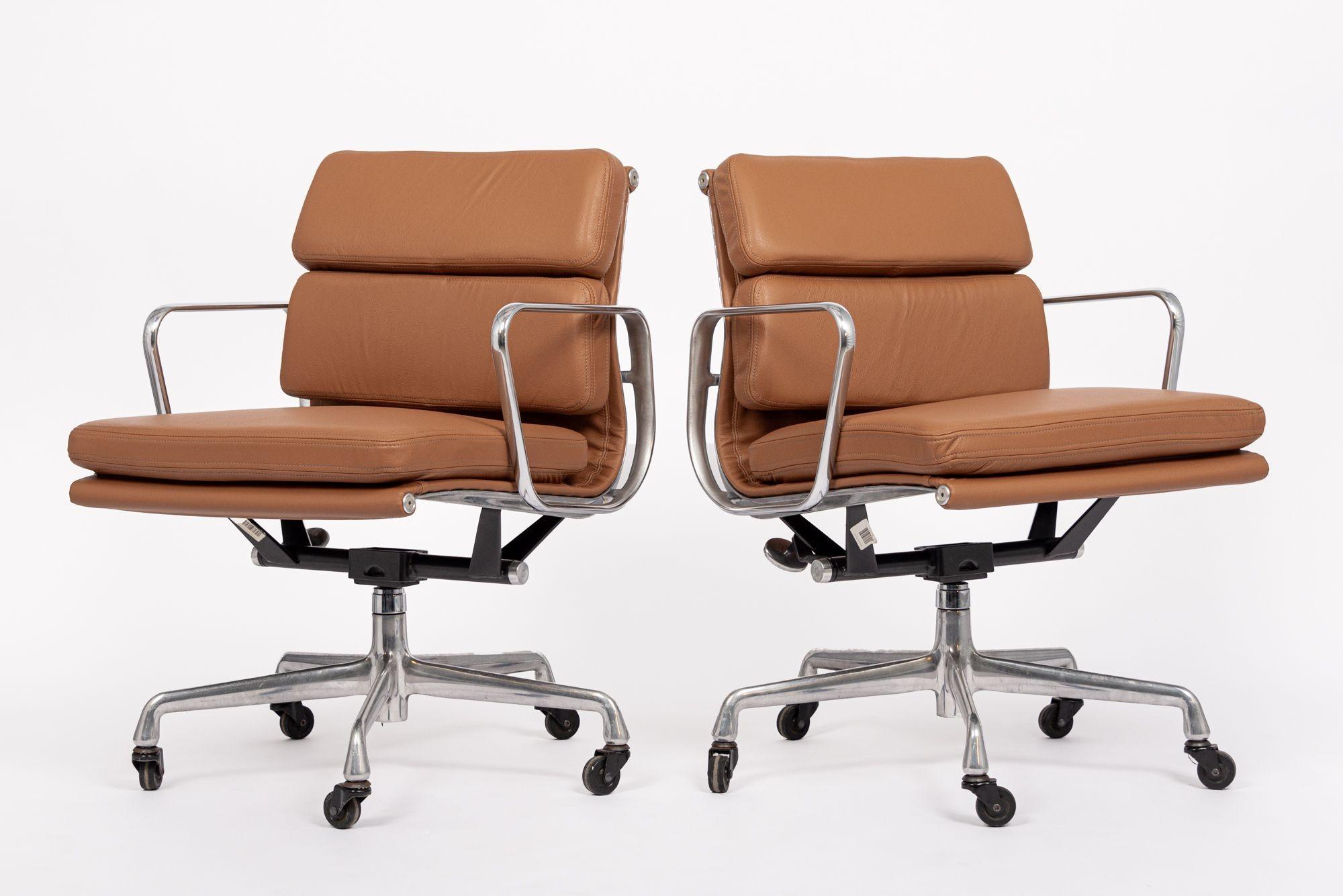 These authentic Eames for Herman Miller Soft Pad Management Height brown leather office chairs from the Aluminum Group Collection were manufactured in the 2000s. This classic mid century modern office chair was first introduced in 1969 by Charles
