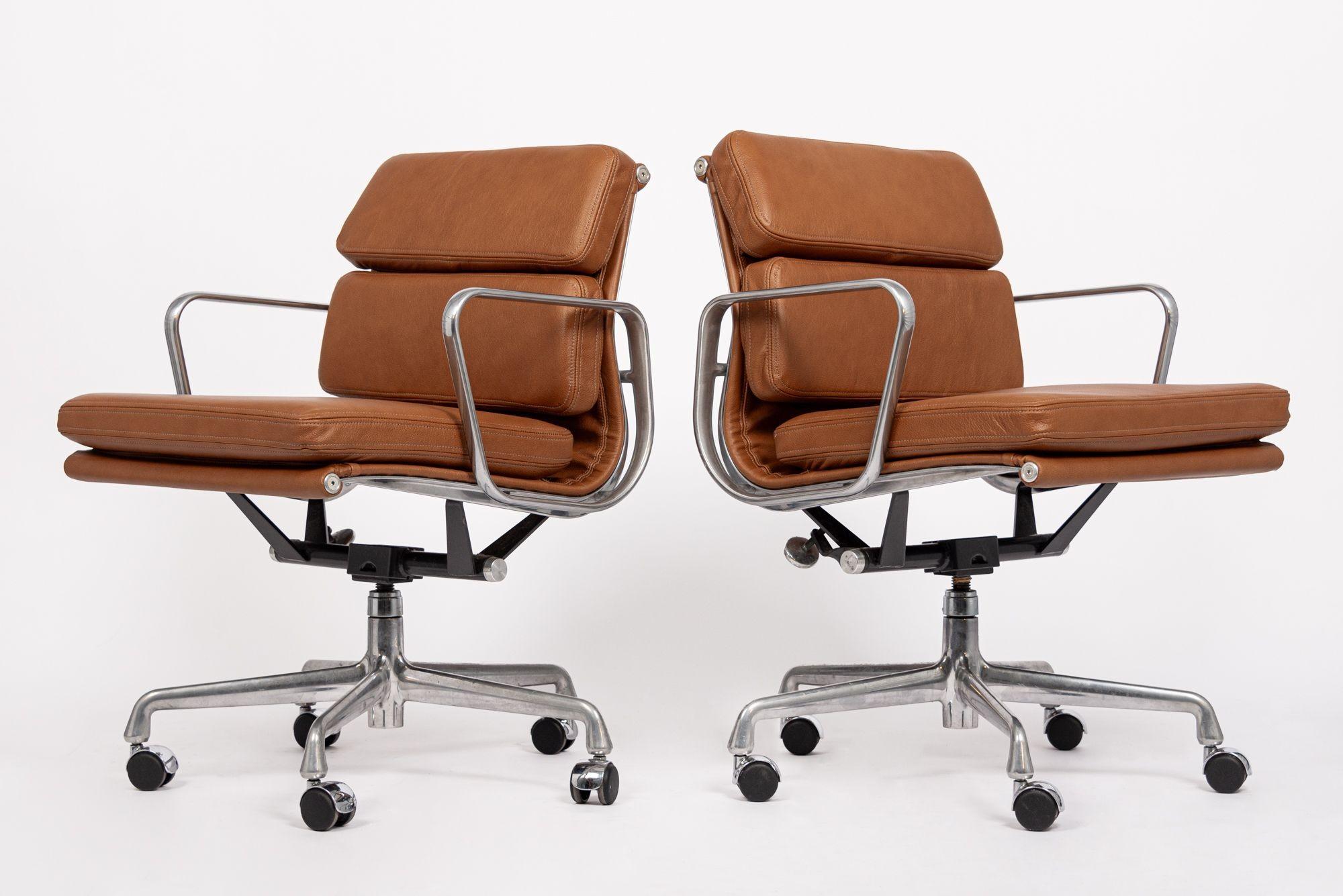 These authentic Eames for Herman Miller Soft Pad Management Height brown leather office chairs from the Aluminum Group Collection were manufactured in the 2000s. This classic mid century modern office chair was first introduced in 1969 by Charles