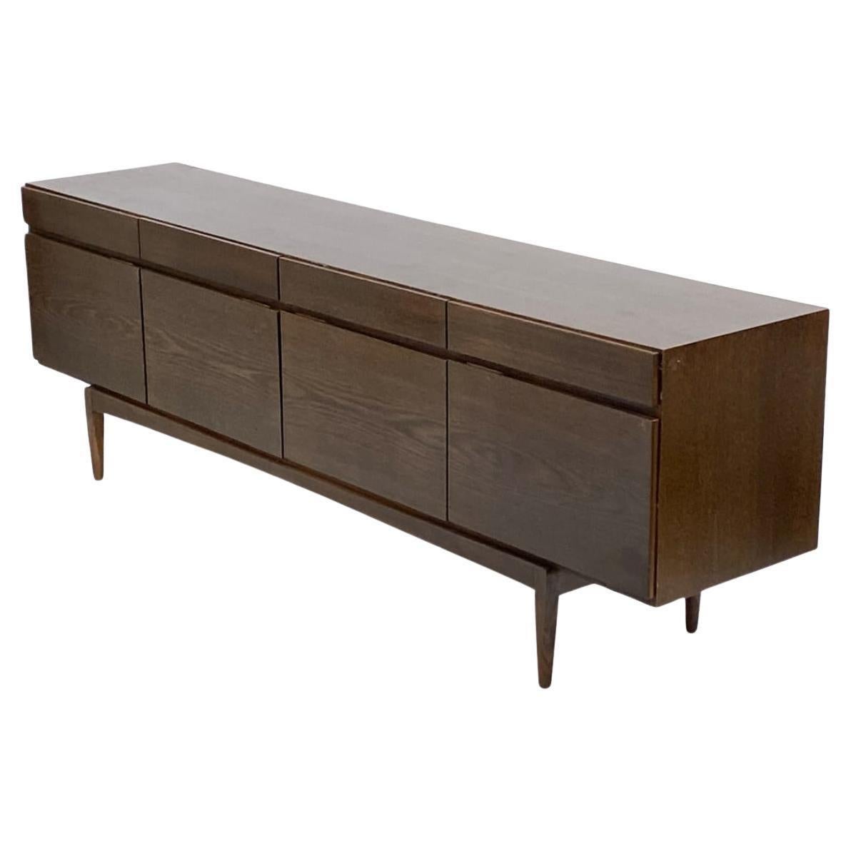 Mid century brown oak credenza by Ib Kofod-Larsen for Faarup Møbelfabrik Model FA66. Can be used as a credenza / sideboard / storage / media cabinet. Danish Modern design in completely original condition shows normal wear and use. Beautiful brown