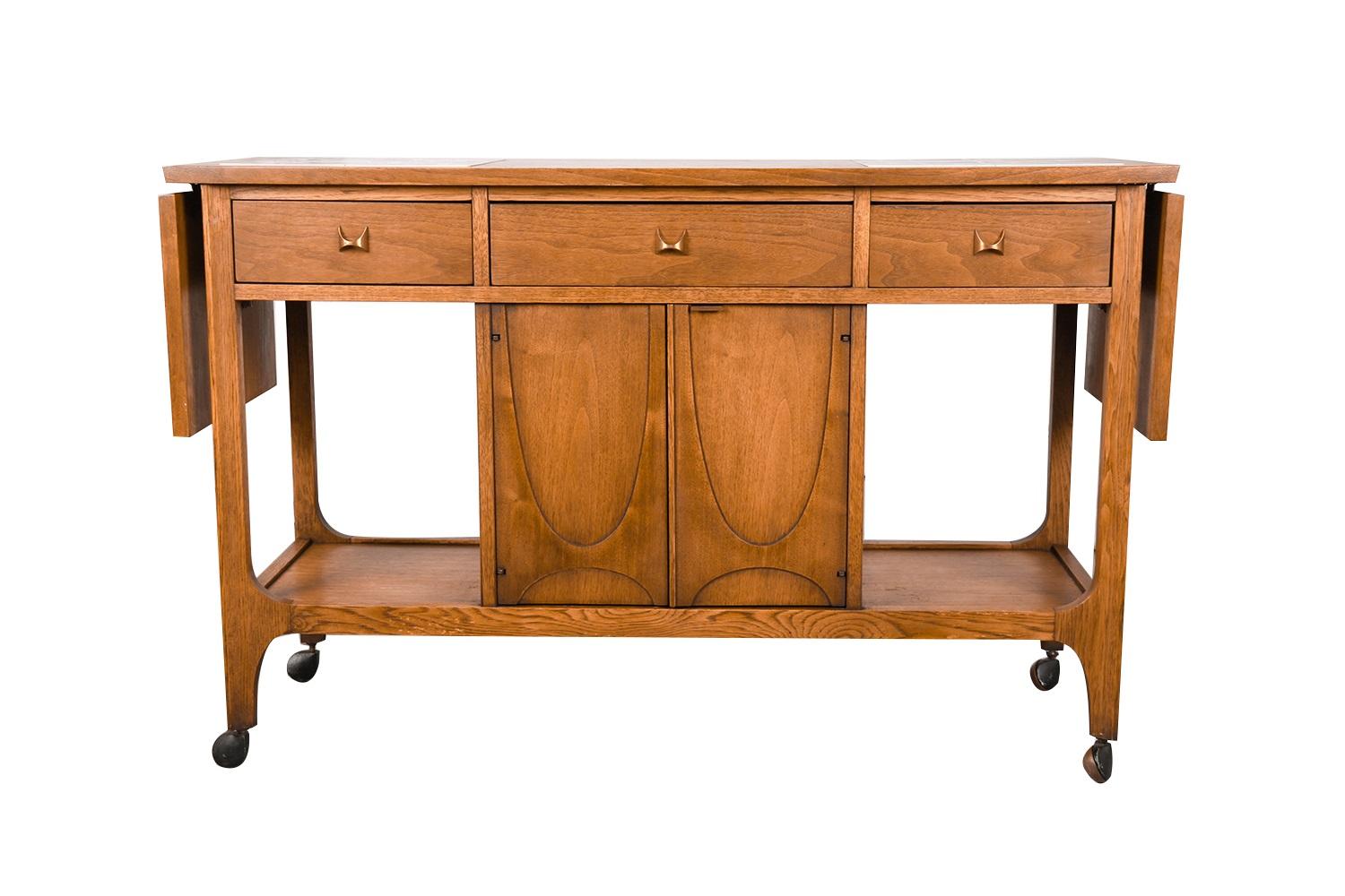 Absolutely beautiful and functional Mid-Century modern drop leaf tile top bar cart console table circa 1960s, from the Brasilia Premier collection by Broyhill Furniture. This absolute jewel remains in nearly pristine condition. The Brasilia line is