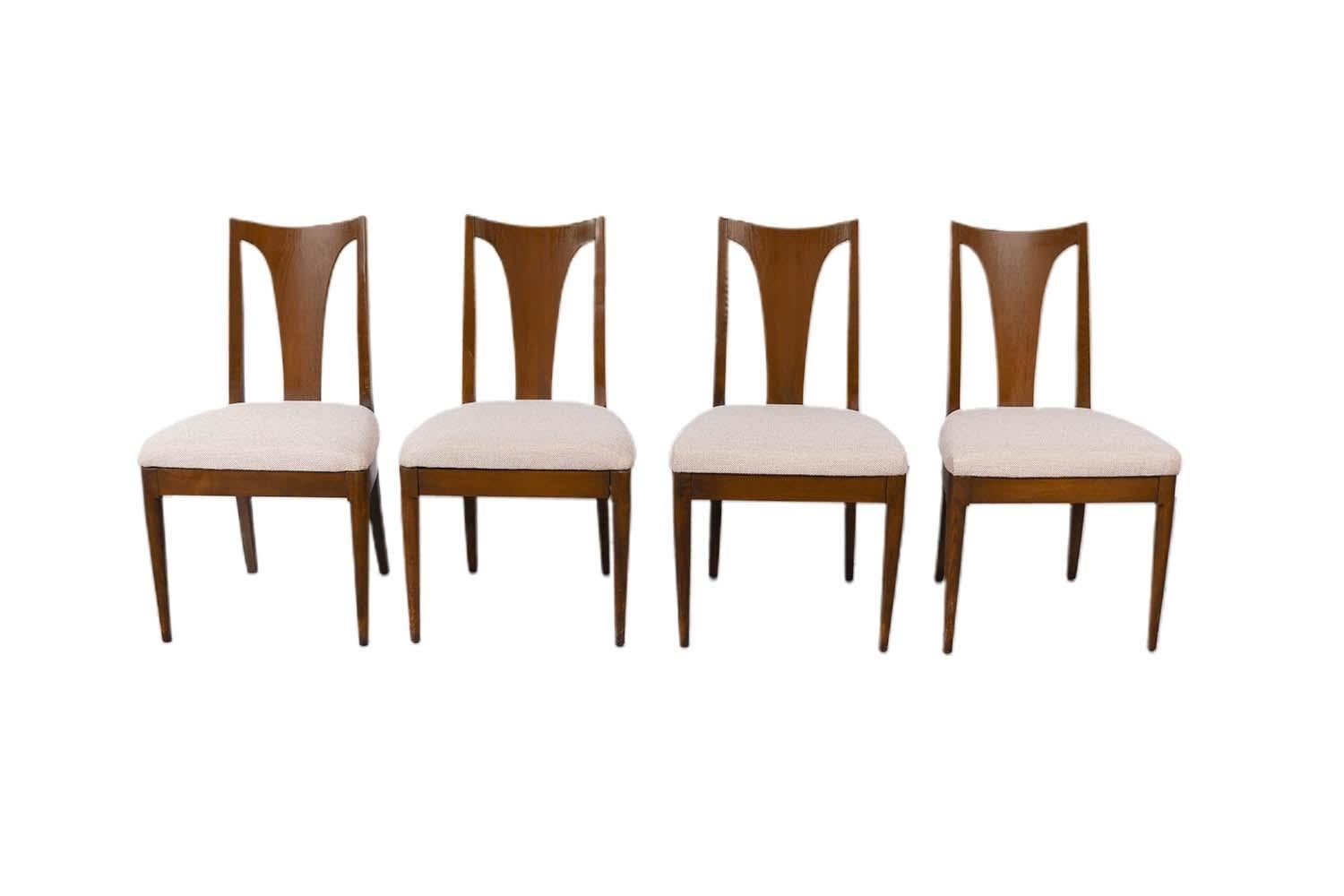 Set of four stunning Mid Century Modern Walnut dining chairs from Broyhill Brasilia II collection. Features four side chairs in Newly Reupholstered High density foam dacron upholstery batting and 100% polyester tweed fabric seats. The arm chairs are