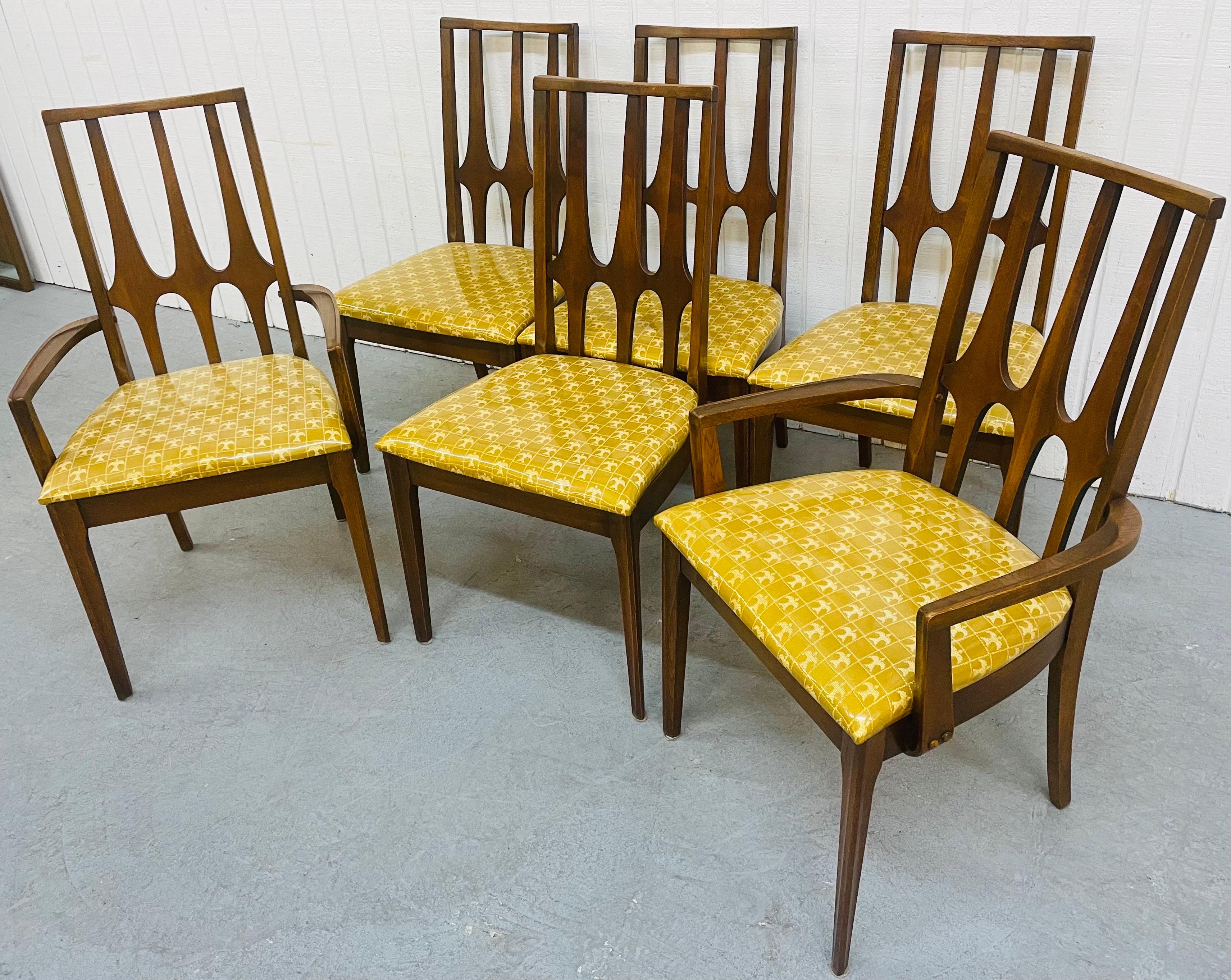 This listing is for a set of six Mid-Century Broyhill Brasilia Walnut Dining Chairs. Featuring original upholstered seats, sculpted high back rests, and a beautiful walnut finish.