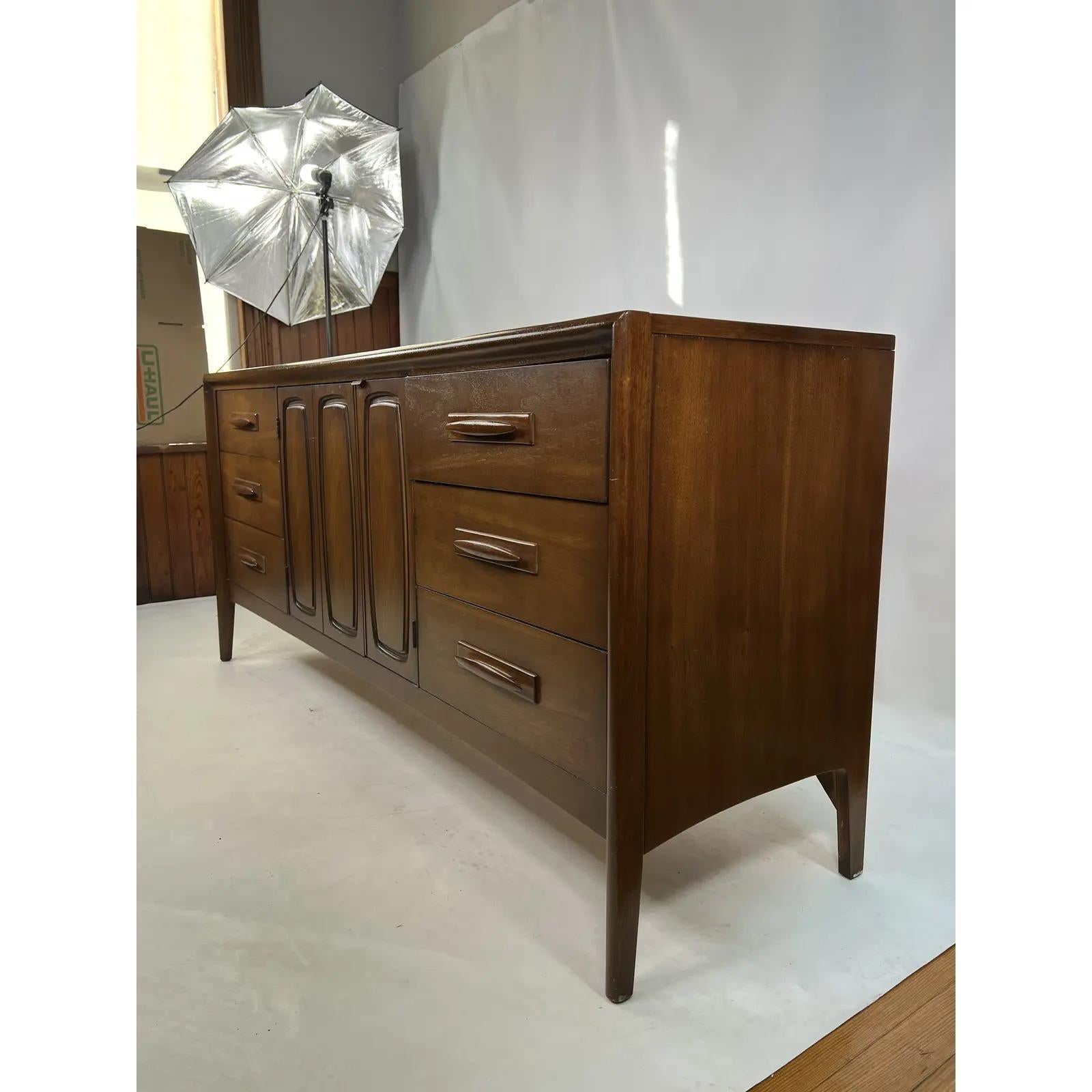This 1950s credenza from the Emphasis series by Broyhill has a total of nine drawers. It was beautifully crafted and manufactured. It could also be used as a dresser if desired.