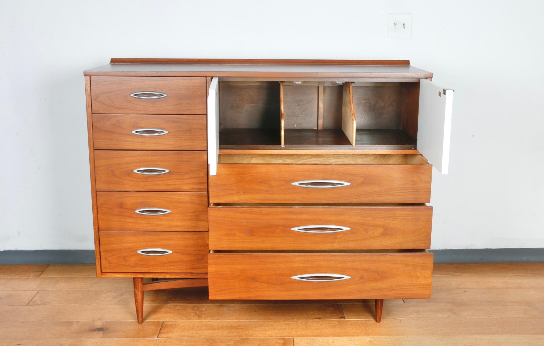 Amazing well designed walnut wood Highboy dresser. Has nice detailed top working doors. Has been refinished and left im excellent condition. Legs are all sturdy and strong. Great for any bedroom with lots of storage space.