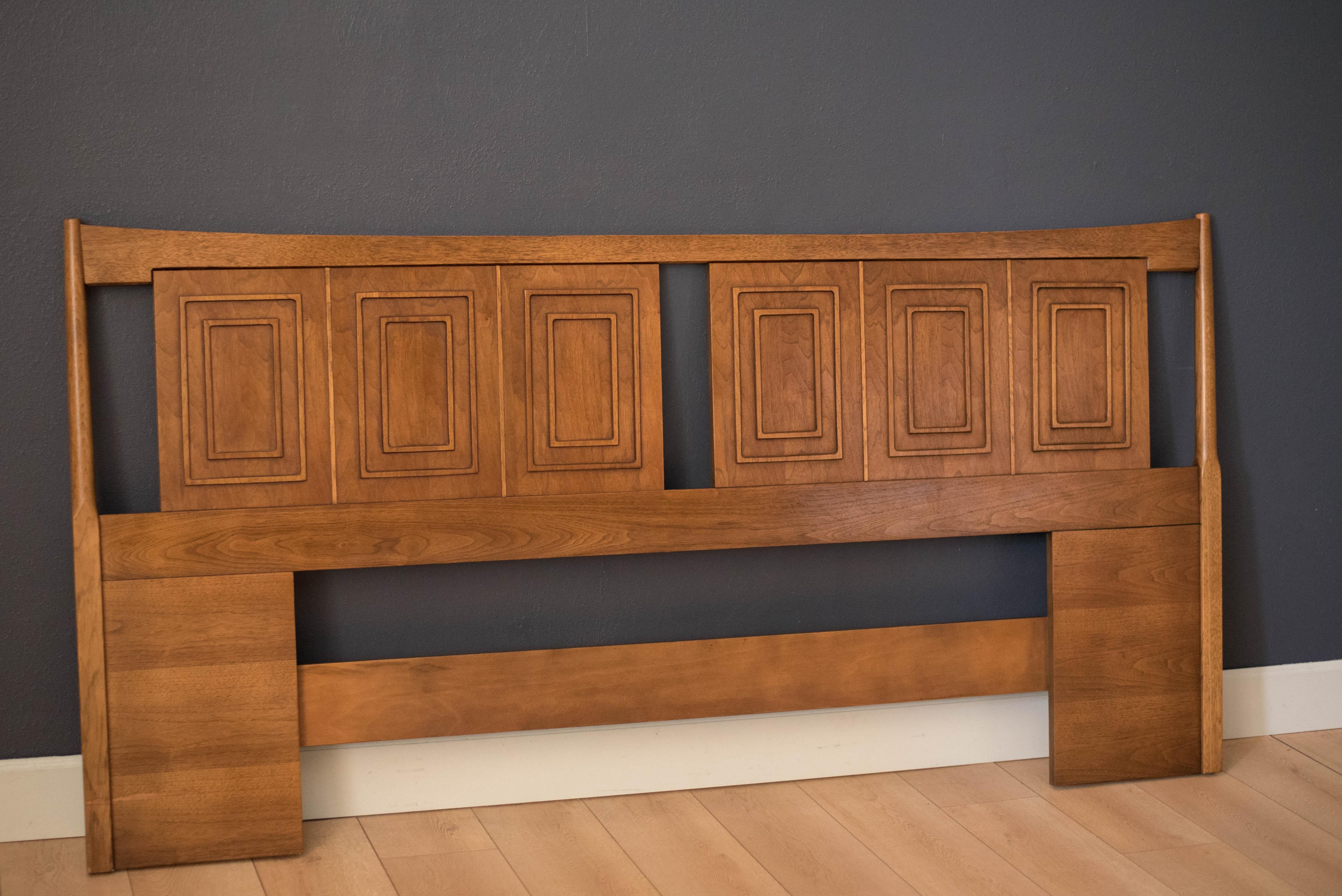 Vintage Broyhill Sculptra King size headboard in walnut and oak. This piece displays the line's signature inset picture frame design and sculpted arches. Nightstands are unavailable. 