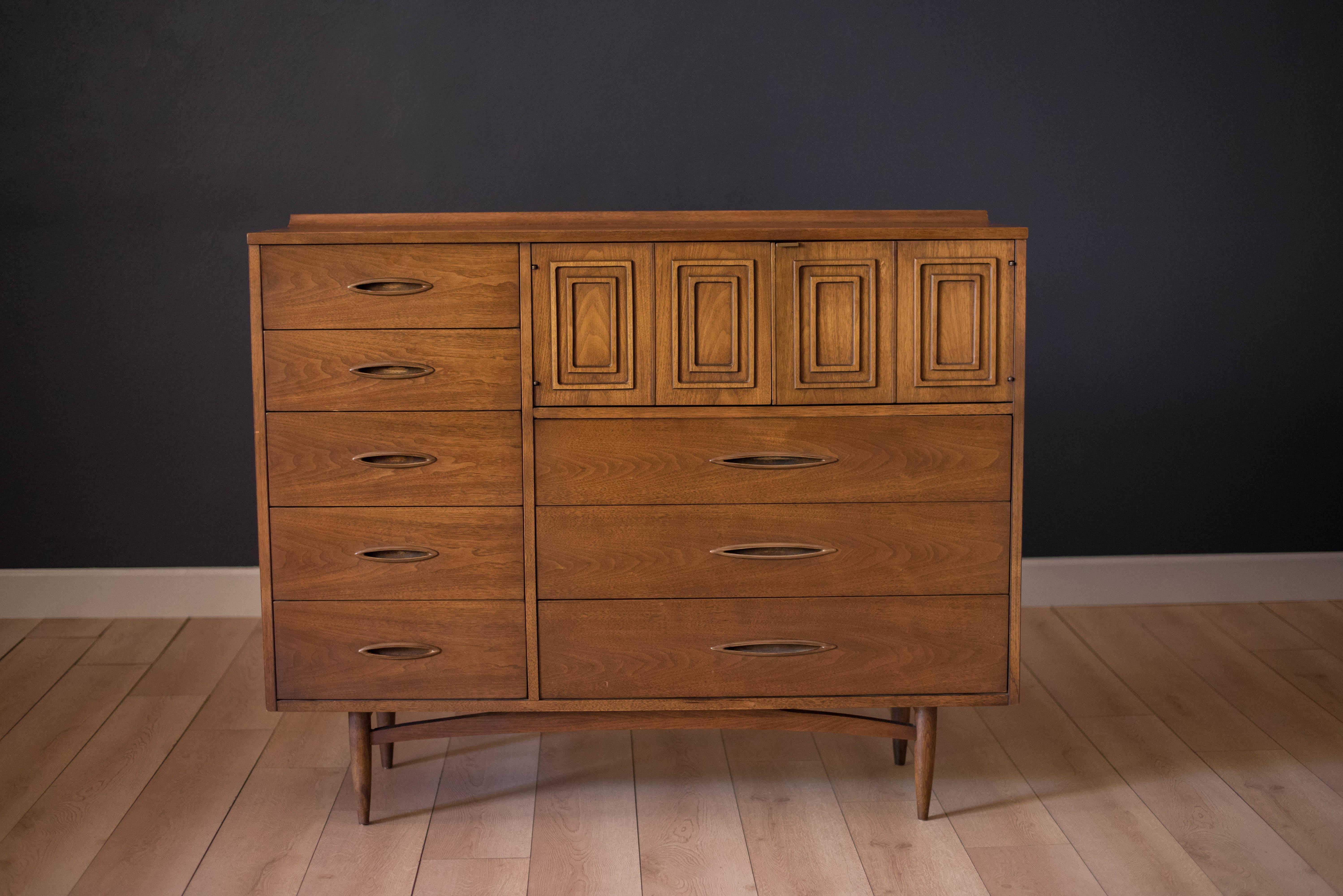 Vintage Broyhill Premier Sculptra Magna chest in walnut and oak. This piece offers plenty of storage space with eight drawers and an open cabinet with two dividers. Features the line's signature cat eye pulls and sculpted raised lip.