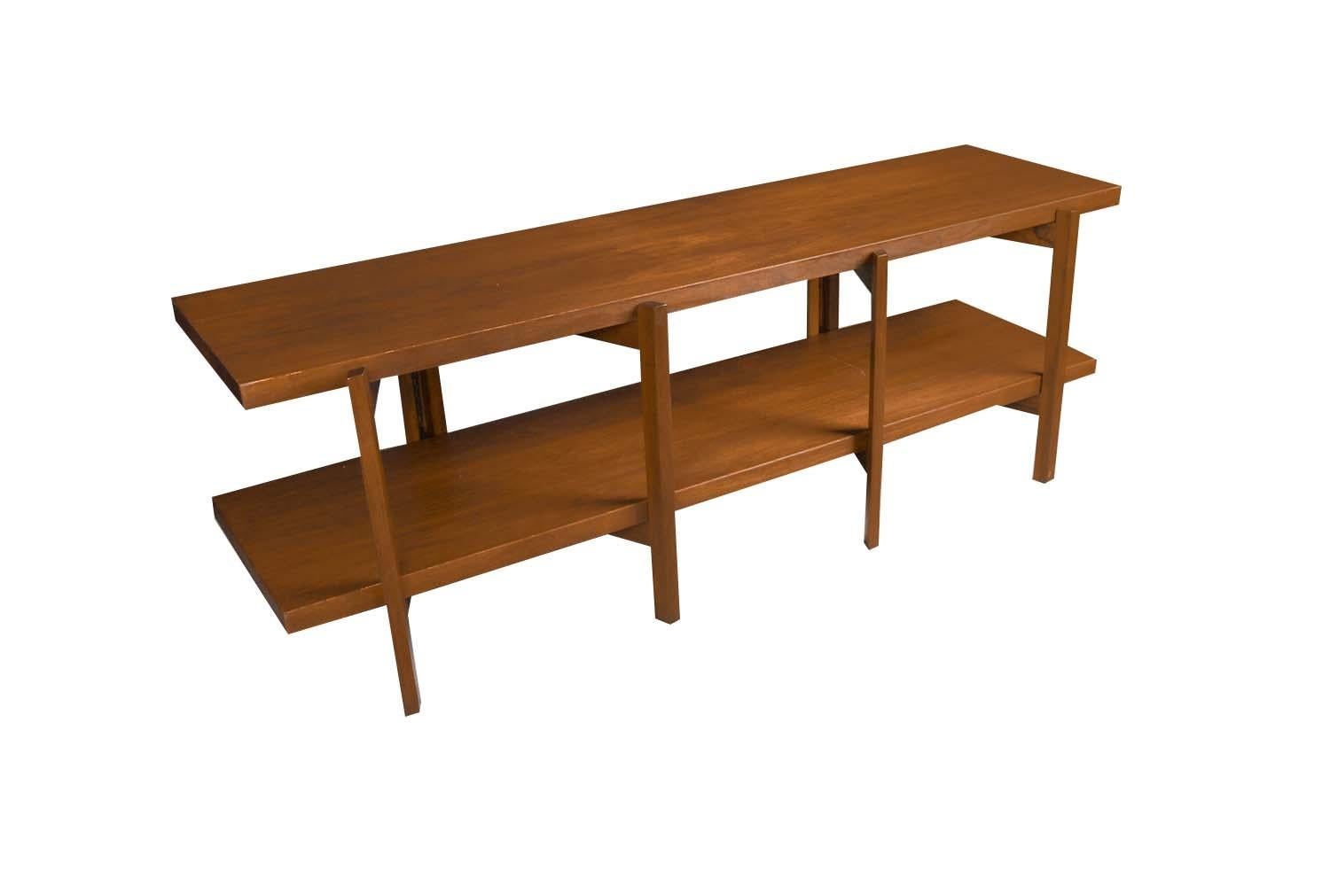 Midcentury Bruno Mathsson Danish Modern style two tier walnut table with folding gateleg base, circa 1960s. This versatile long bench form table can be used as a display table, accent table or media stand. Features beautifully grained walnut