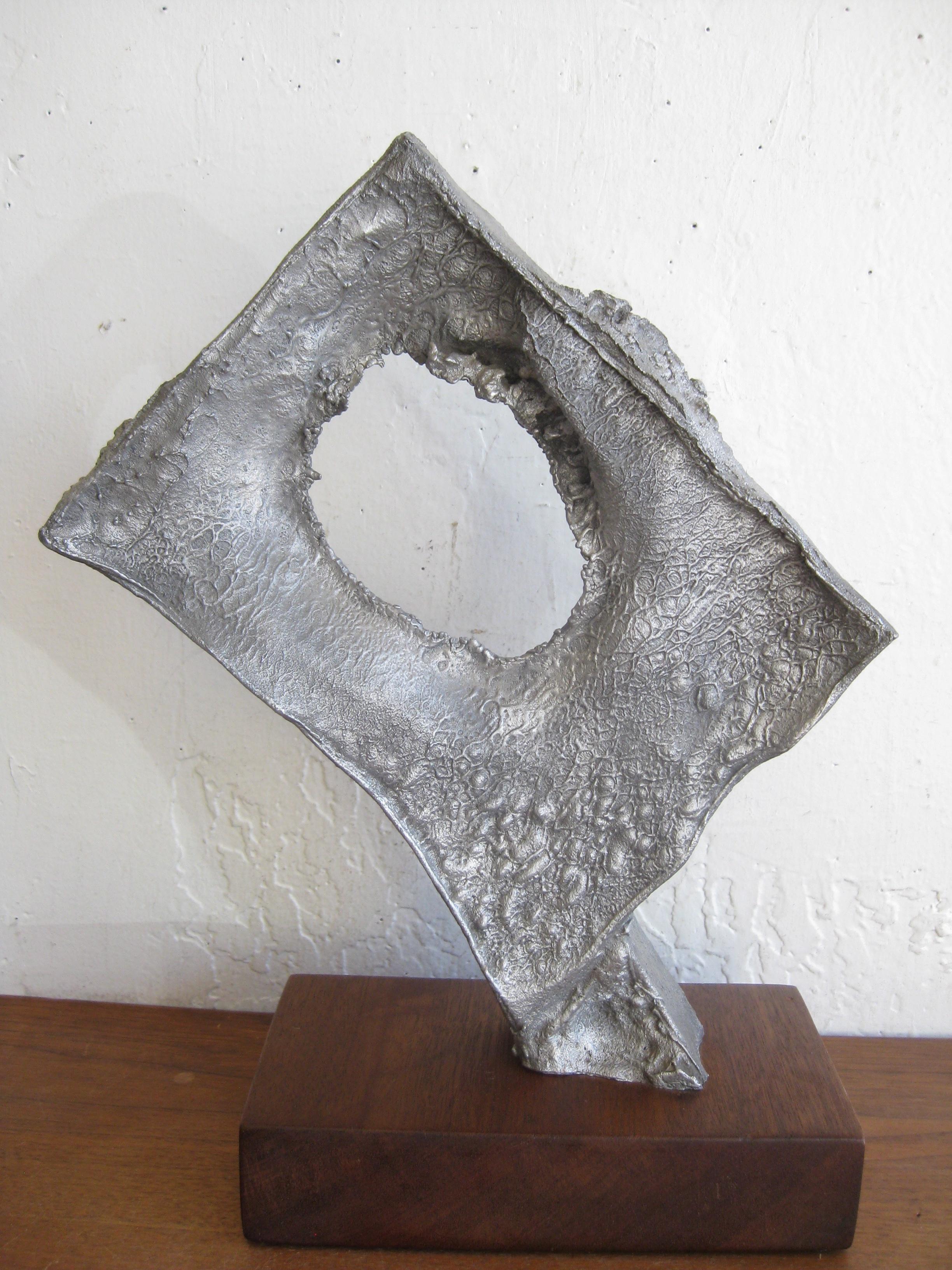 Wonderful Mid-Century Modern abstract Brutalist cast aluminum sculpture dating from the 1960s. I cannot find any signatures or marks but made very well. Wonderful form and design. In the manner of Donald Drumm. Mounted on a thick piece of solid