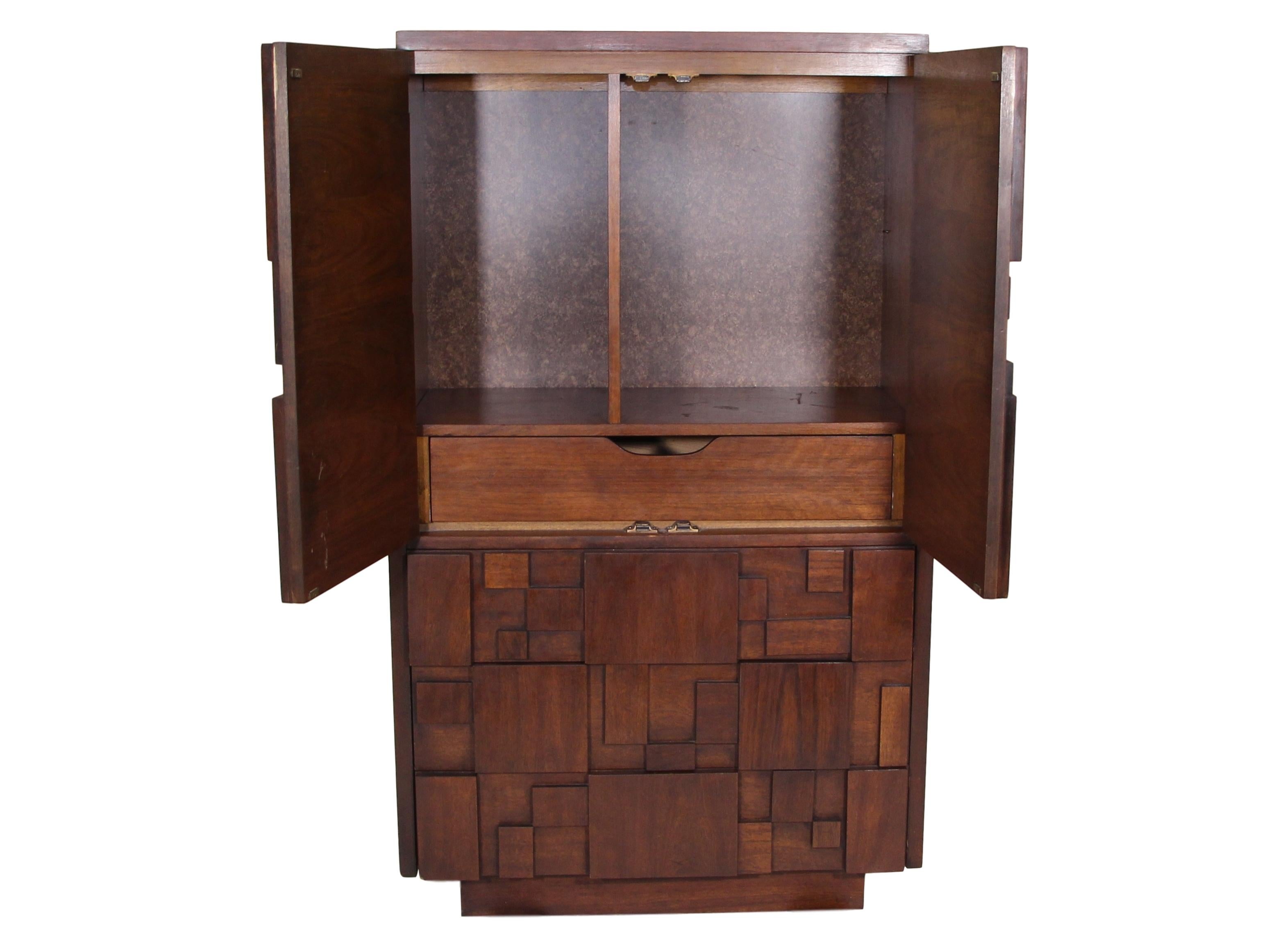 Amazing midcentury American walnut Brutalist single unit 2 door upper cabinets and lower 3-drawer Armoire by Lane. Stamped in a top drawer.

Very good condition. There are 3 repairs on the unit. There is a repair on the top right side. There is a