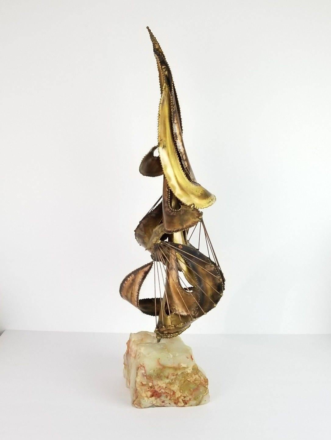 Mid-Century Modern Brutalist abstract sculpture. Sculpture is made of patinated brass with stone base. The twisting wire rods suggest a sailboat, and give the piece a nautical feel.