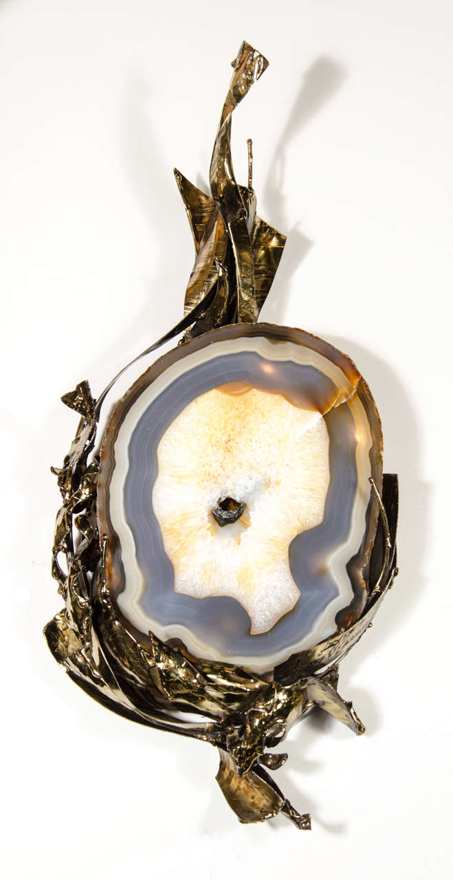 This stunning and unique Mid-Century Modern sculpture was realized by the esteemed sculptor Marc D'Haenens in Belgium, circa 1970. It features an exquisite jewel like geode in the center- with organic undulating forms in cream and blue-grey tones.