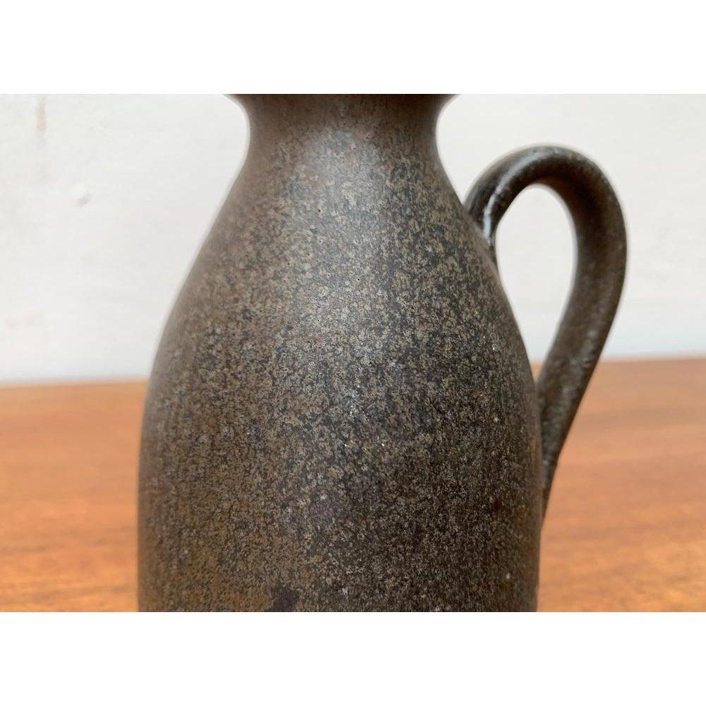 Mid-Century German Brutalist Carafe Vase in the style of Gerhard Liebenthron, 1960s, in None conditions. Designed 1960 to 1969

Additional information:
Materials: Ceramic
Color: Brown
Styles: Brutalist, Mid-Century Modern
Country of Origin: