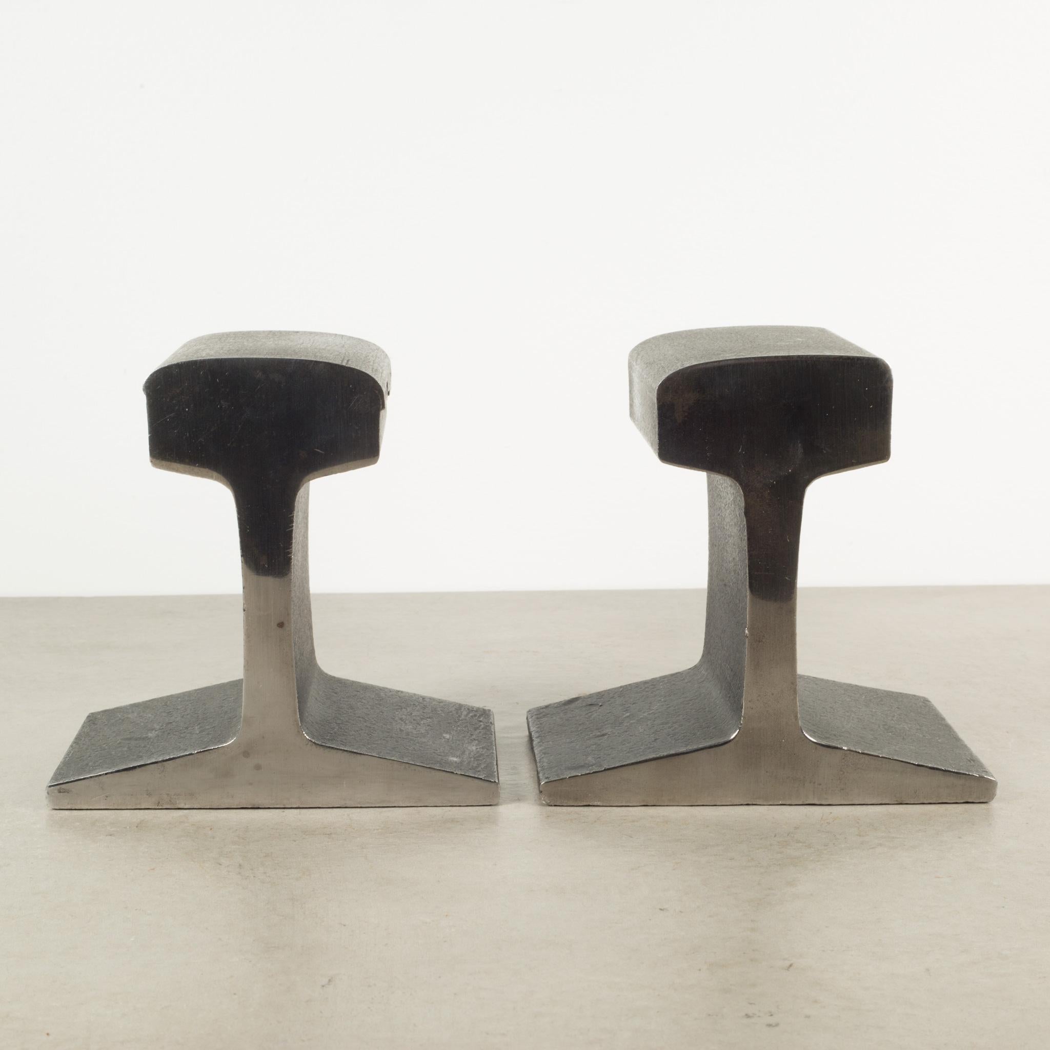 ABOUT

A pair of MCM Brutalist heavy railroad track bookends with highly polished chrome back and front and textured black sides. Original green felt to bases.

 CREATOR Unknown.
 DATE OF MANUFACTURE c.1960s.
 MATERIALS AND TECHNIQUES Steel,