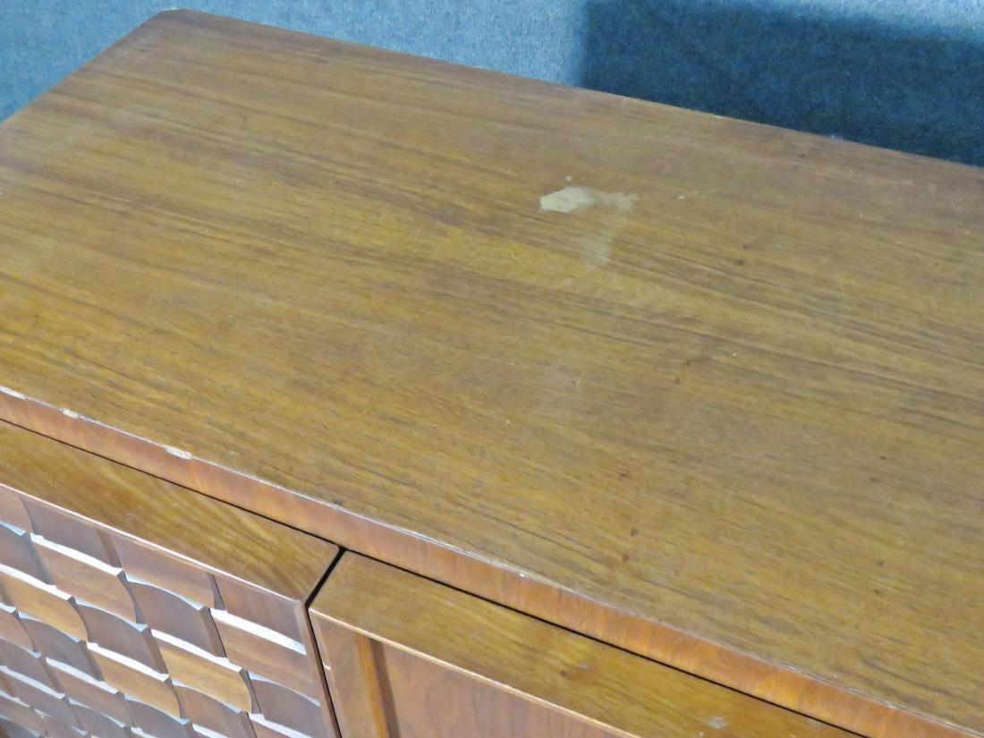 Vintage Brutalist-style dresser combining a patterned surface with rich woodgrain, accented by metal handles. This sturdy Mid-Century piece is full of crafted quality and is sure to be a lasting addition to any home. Please confirm item location
