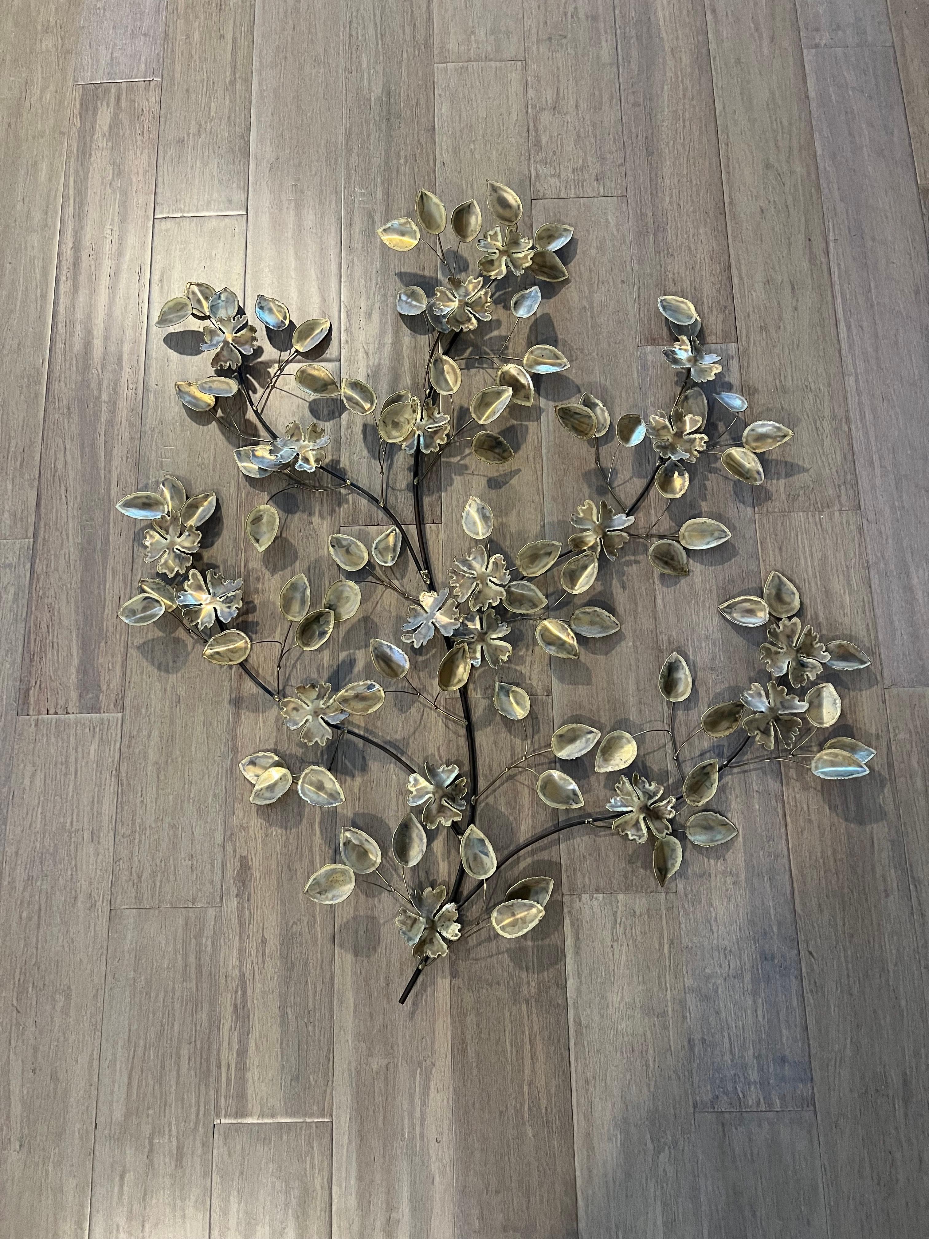 Mid Century Brutalist Floral Wall Sculpture in the style of Curtis Jere . Nice light silvery gold finish. Brutalist torch cut and welded. Perfect for above a mantel or bed. Nice textural piece to accent any room.