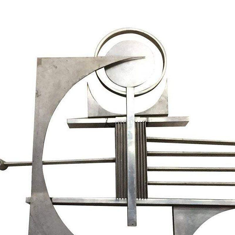 Brutalist free-form aluminum & steel art wall sculpture featuring brushed and polished piece cutting into corners, vents, and round shapes brought together by a centralized 