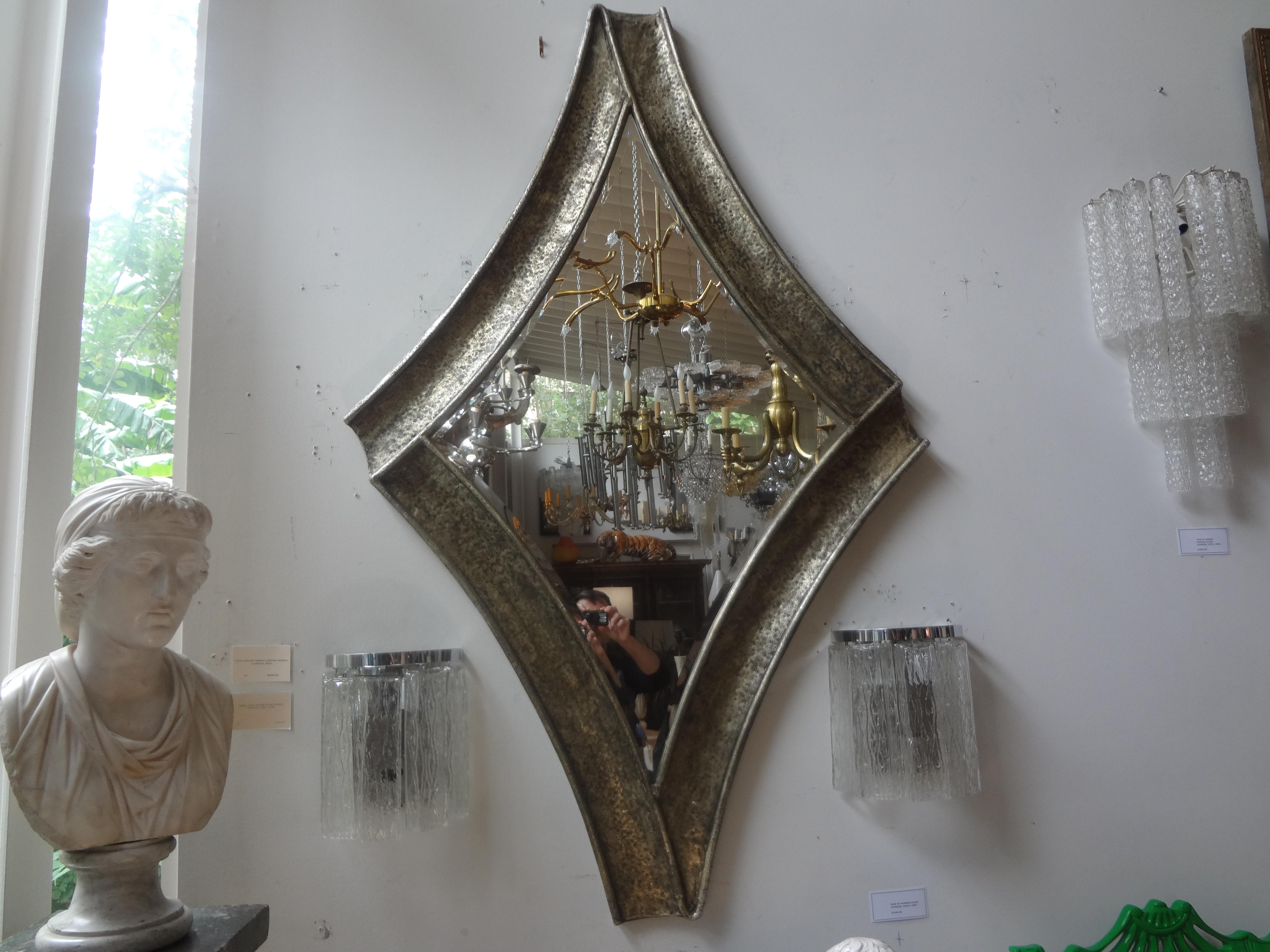 Midcentury Brutalist hammered metal beveled mirror.
Unique large midcentury Brutalist hammered metal beveled mirror. This versatile mirror would work well in a variety of interiors.
Great shape!