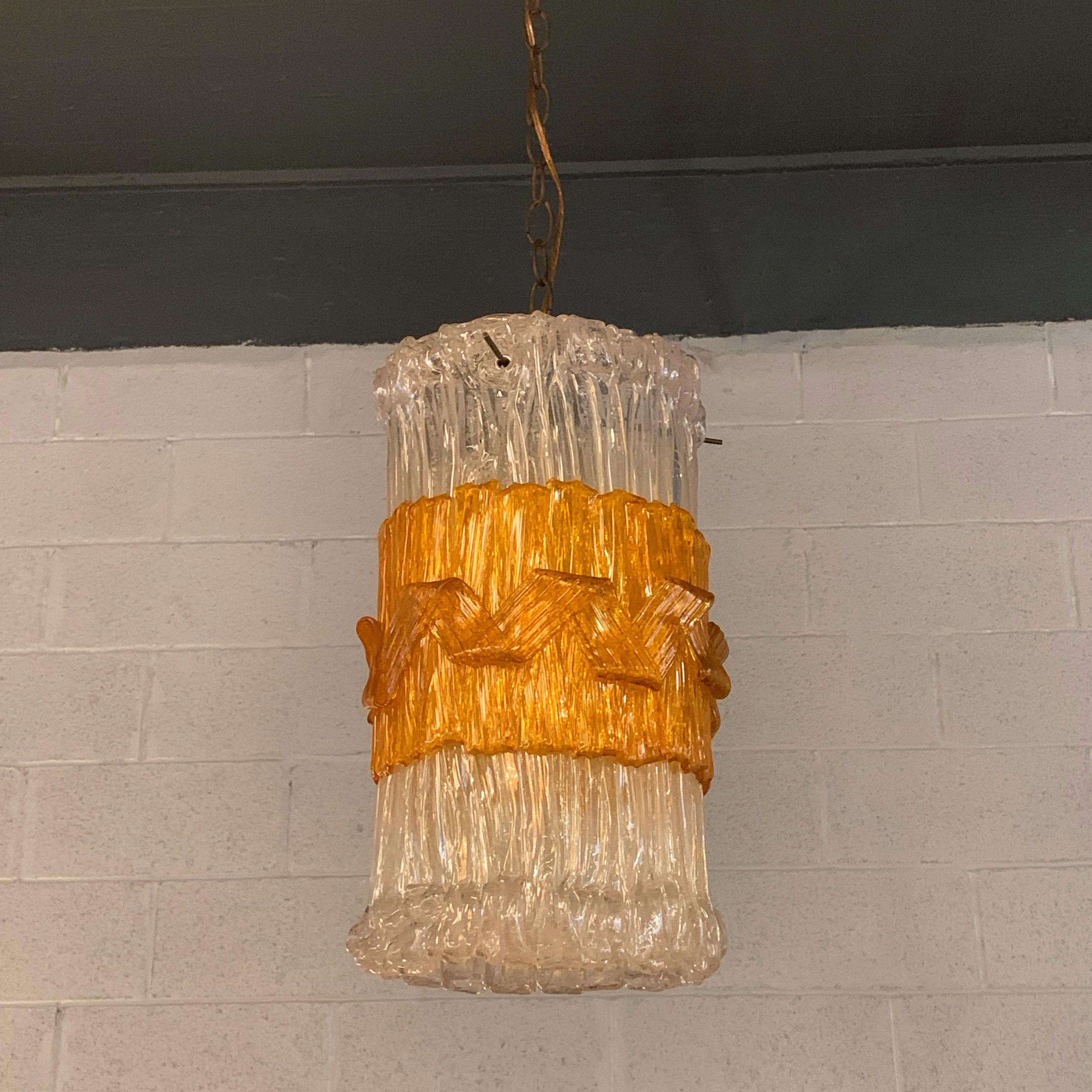 Mid-Century Modern, pendant light features a Brutalist, Lucite cylinder with amber band wired with 40 inches of chain to accept up to a 100 watt bulb.