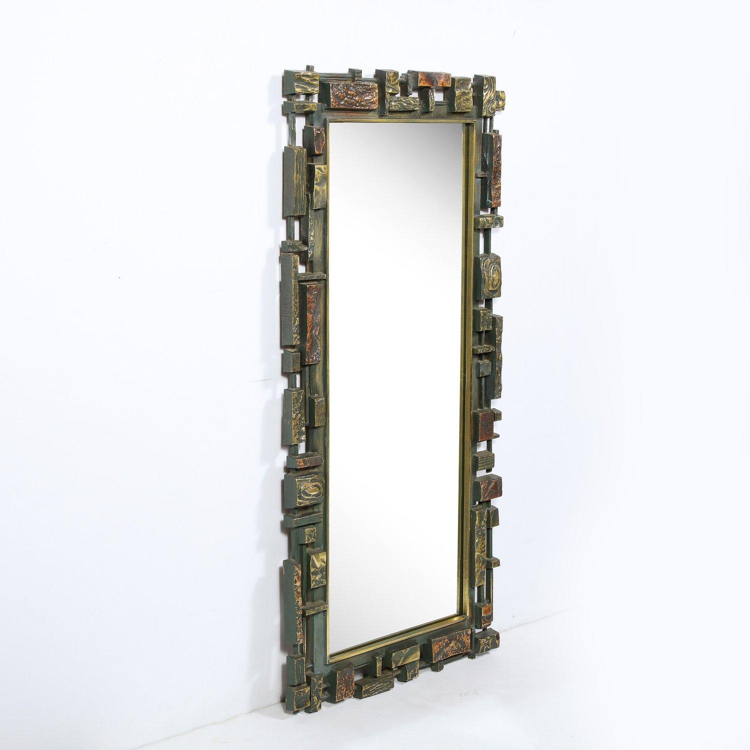 This graphic and sophisticated Mid-Century Modern mirror was realized in the United States circa 1970. It features a rectangular plain mirror center surrounded by an injection moulded thick resin plastic in a finish of bronze and copper. The