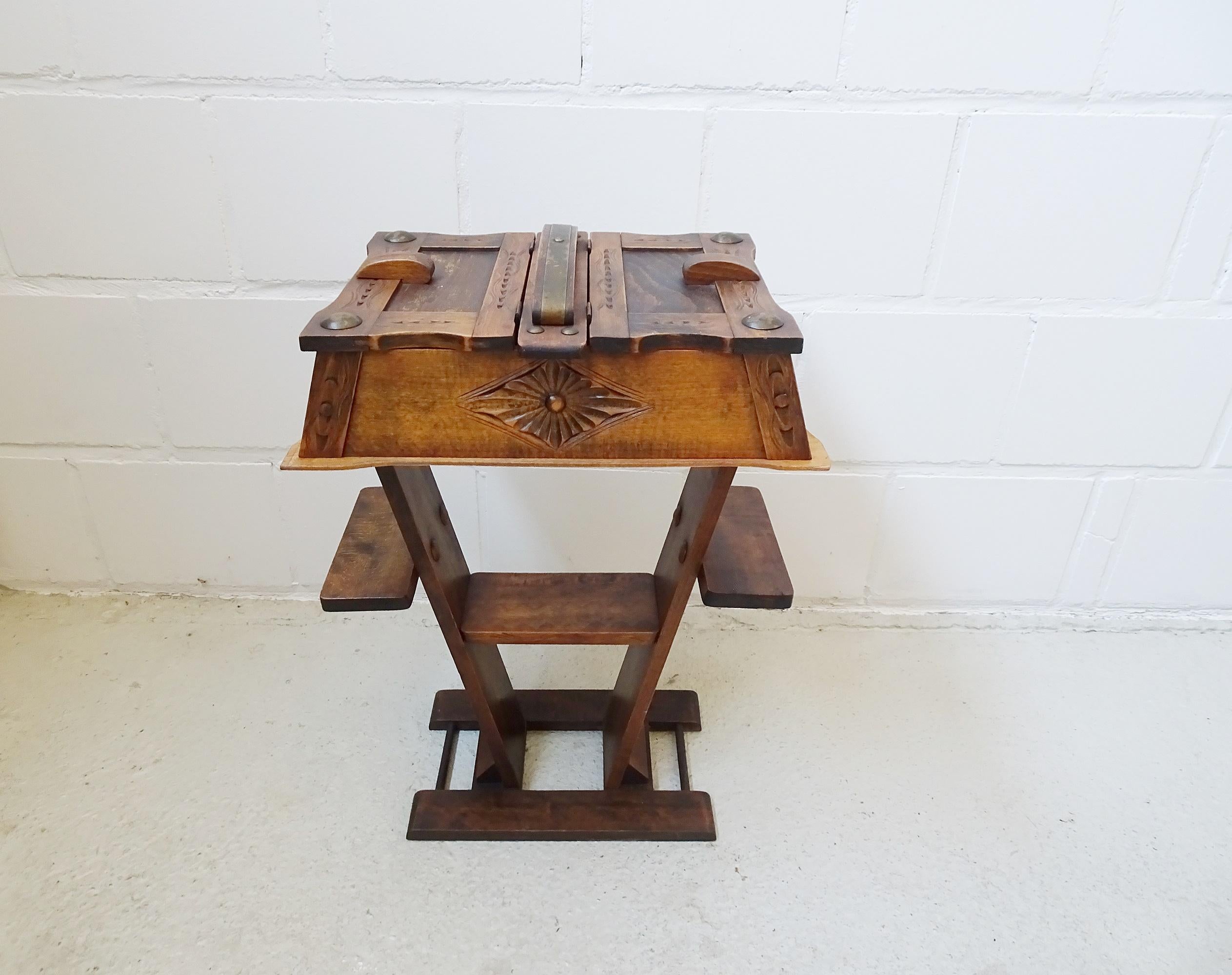 This French work table is an exceptional Art Deco style sewing table from the early 1960s. Brutalist design with carved details and large round metal bezels. The sewing box has a spacious room with two folding openings and three additional storage