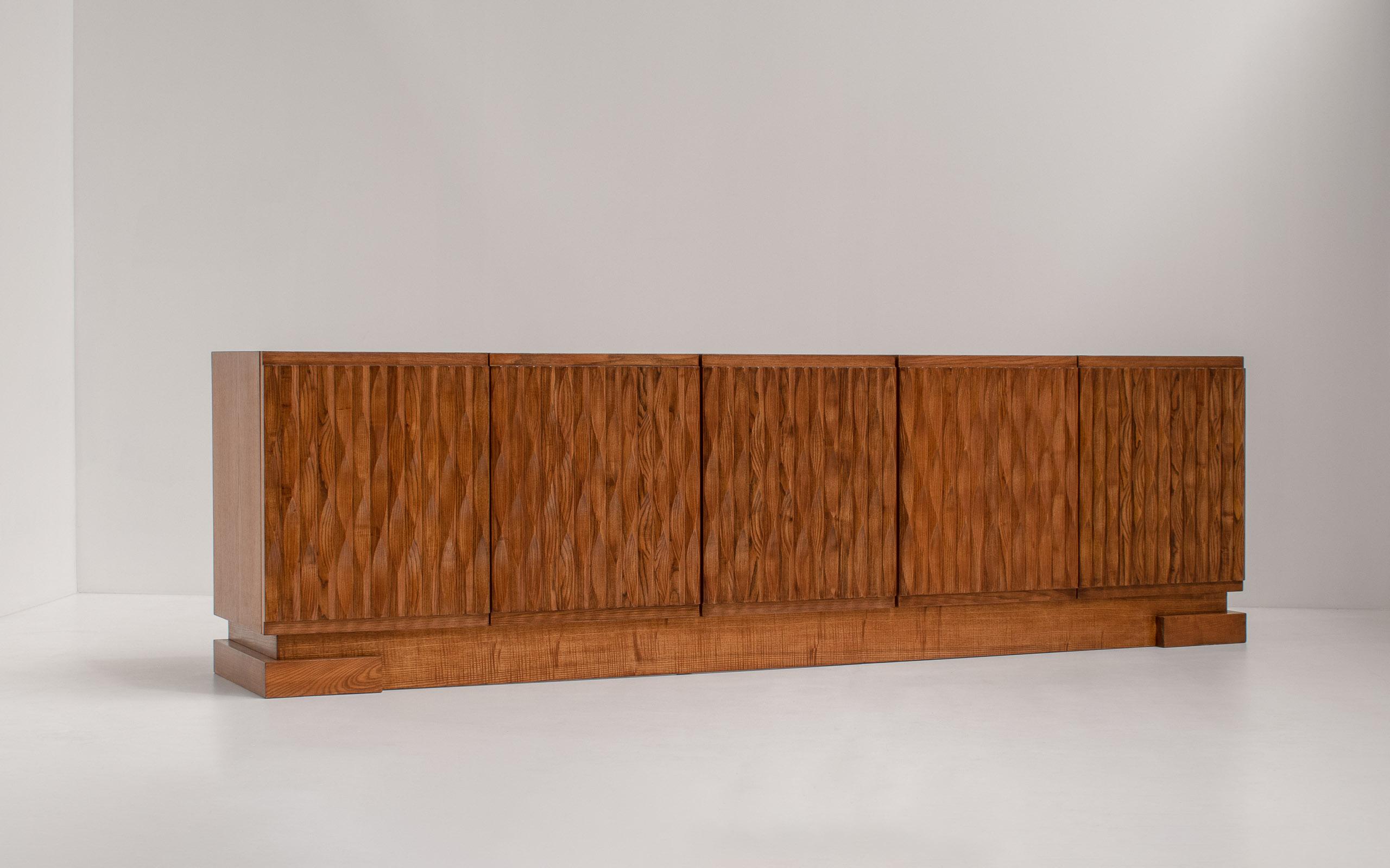 Impressive graphic, brutalist-style design credenza, Belgium 1970s

Because of its dimensions and the beautiful sculptured doors, it beats all the other sideboards out there. The woodwork is out of this world, and the blonde oak gives a delightful