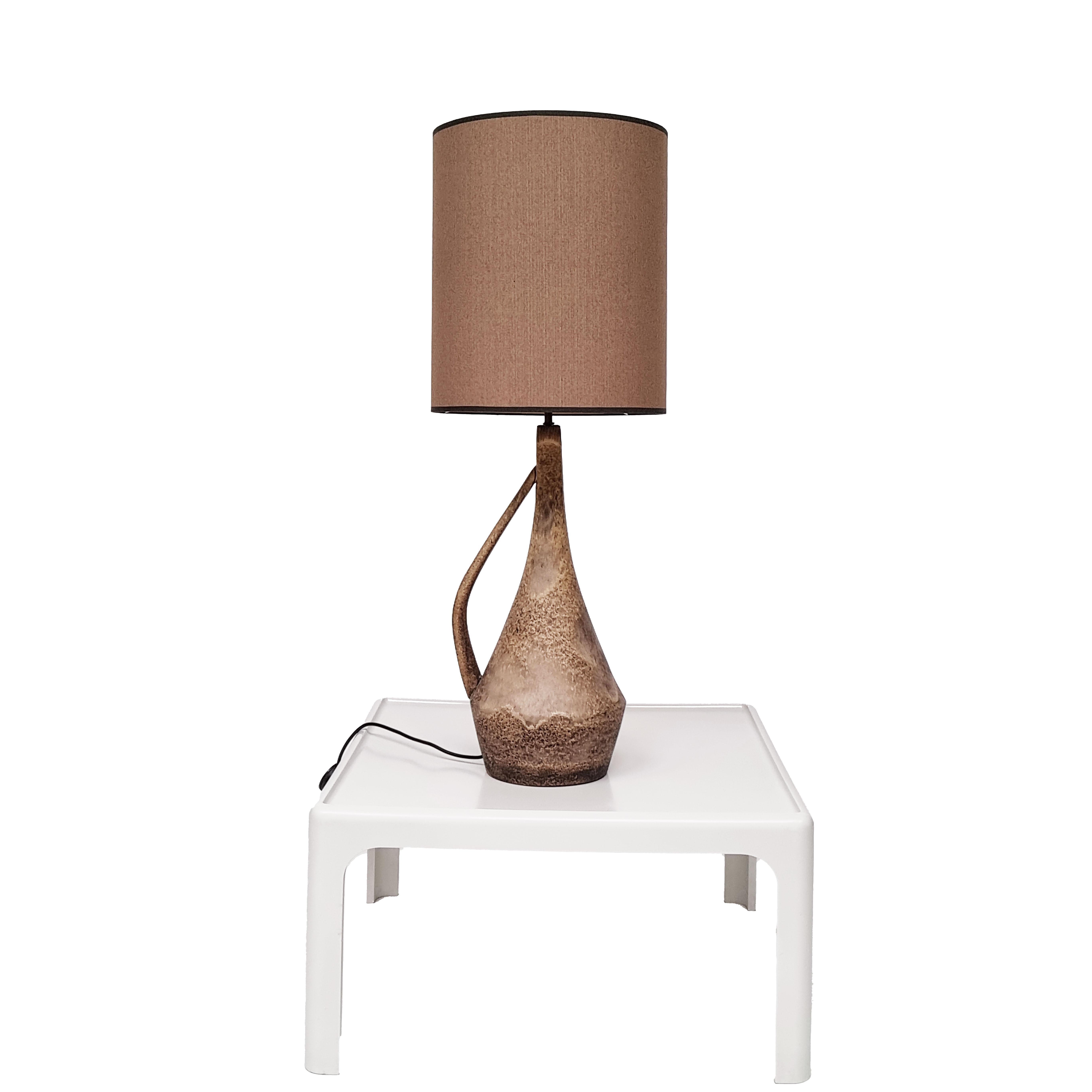 A sizable, handcrafted ceramic table lamp from midcentury France, following the Brutalist style that highlights the inherent, unrefined qualities of clay while maintaining a uniquely exquisite shape.  This table lamp comes with the depicted