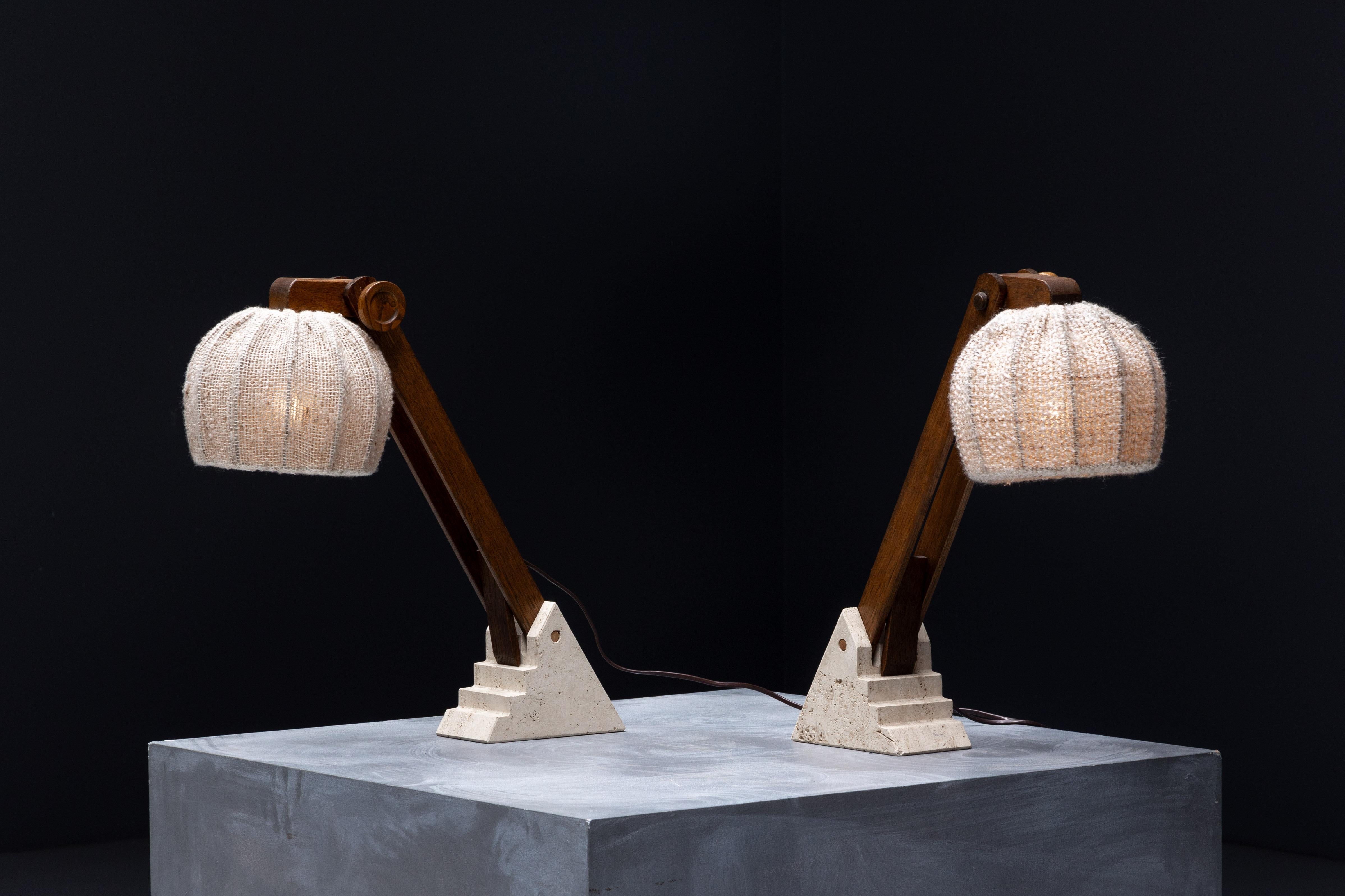 Striking pair of sculptural table lamps, blending mid-century modern design with bold brutalist influences. Each lamp features a handwoven jute shade that casts a warm, ambient glow, softening the strong architectural lines beneath. The angled
