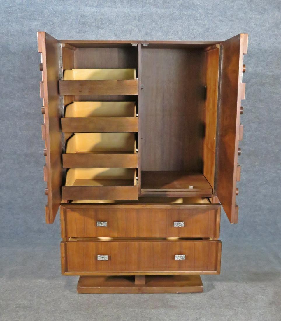 Vintage Brutalist tall cabinet featuring a sculpted designed front in rich walnut grain, two bottom drawers and a spacious storage cabinet.

Please confirm item location with seller (NY/NJ).

 
