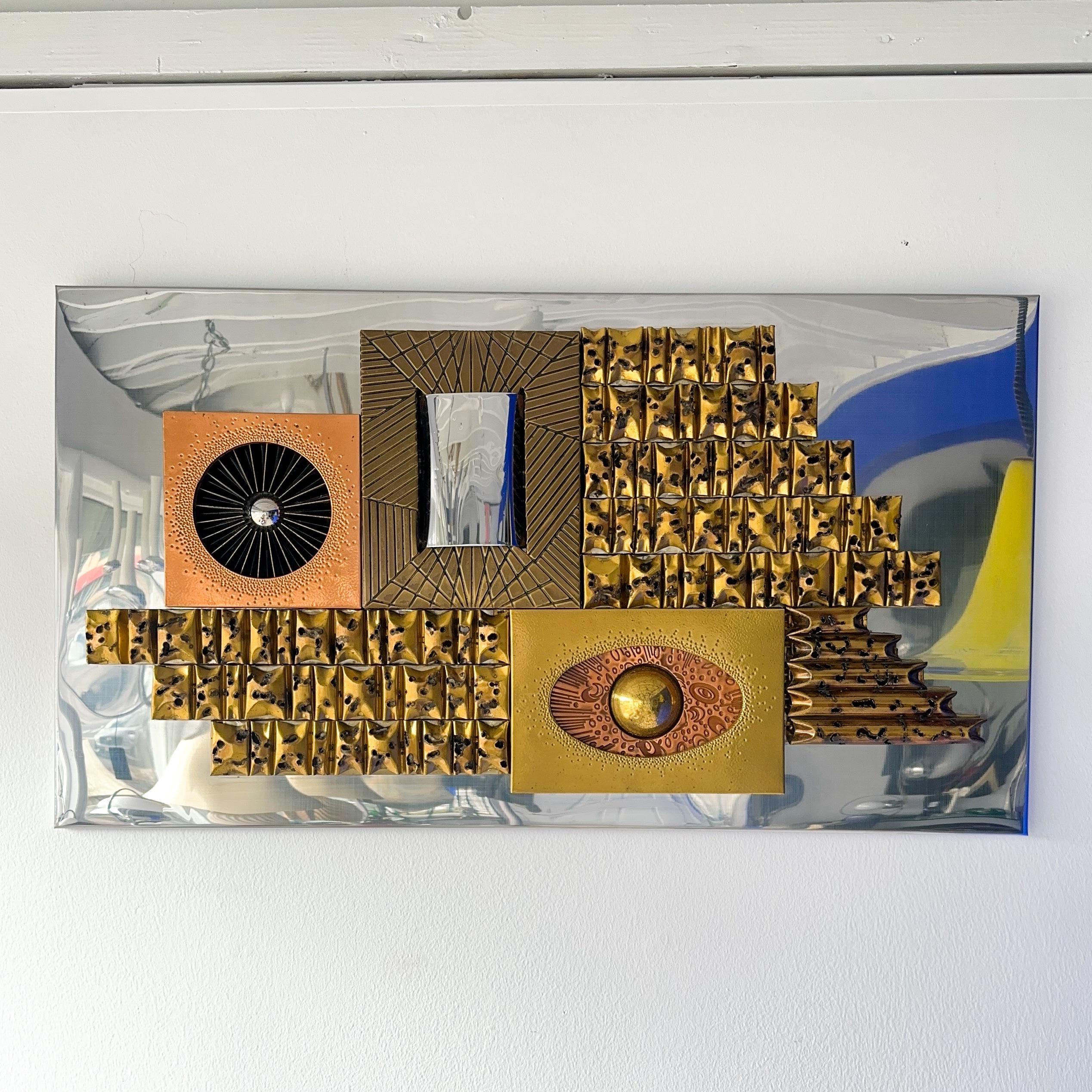 Vintage brutalist wall sculpture attributed to Paul Vanders circa 1950s. Manipulated individual metal pieces are attached to the mirrored chrome back panel. Hammered, folded and torch cut brass, copper, chrome metal offer three dimensional