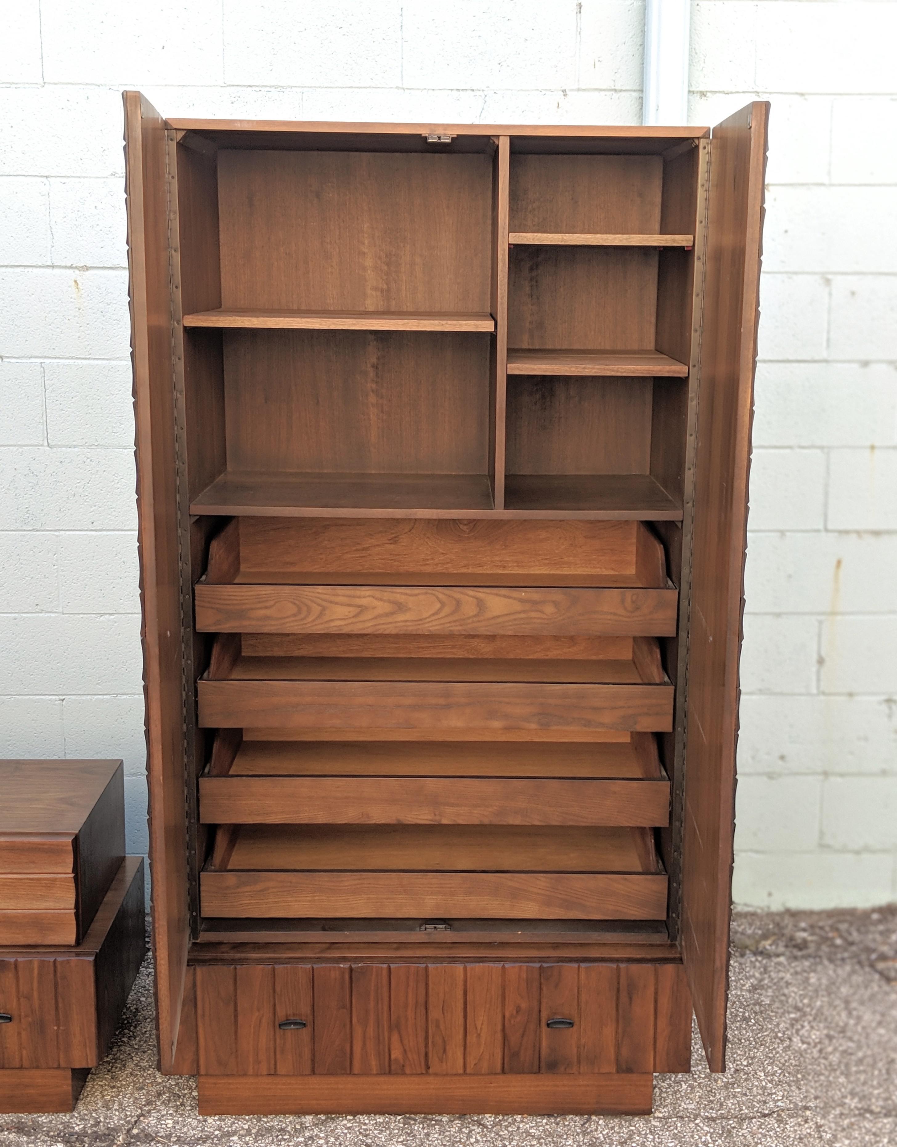 This is a really unique high boy dresser made out of wood and walnut veneer. It has a nice brick or block wood carver fronts. The drawers have rolling support making it sturdy and easy to use. This would look beautiful in any home!