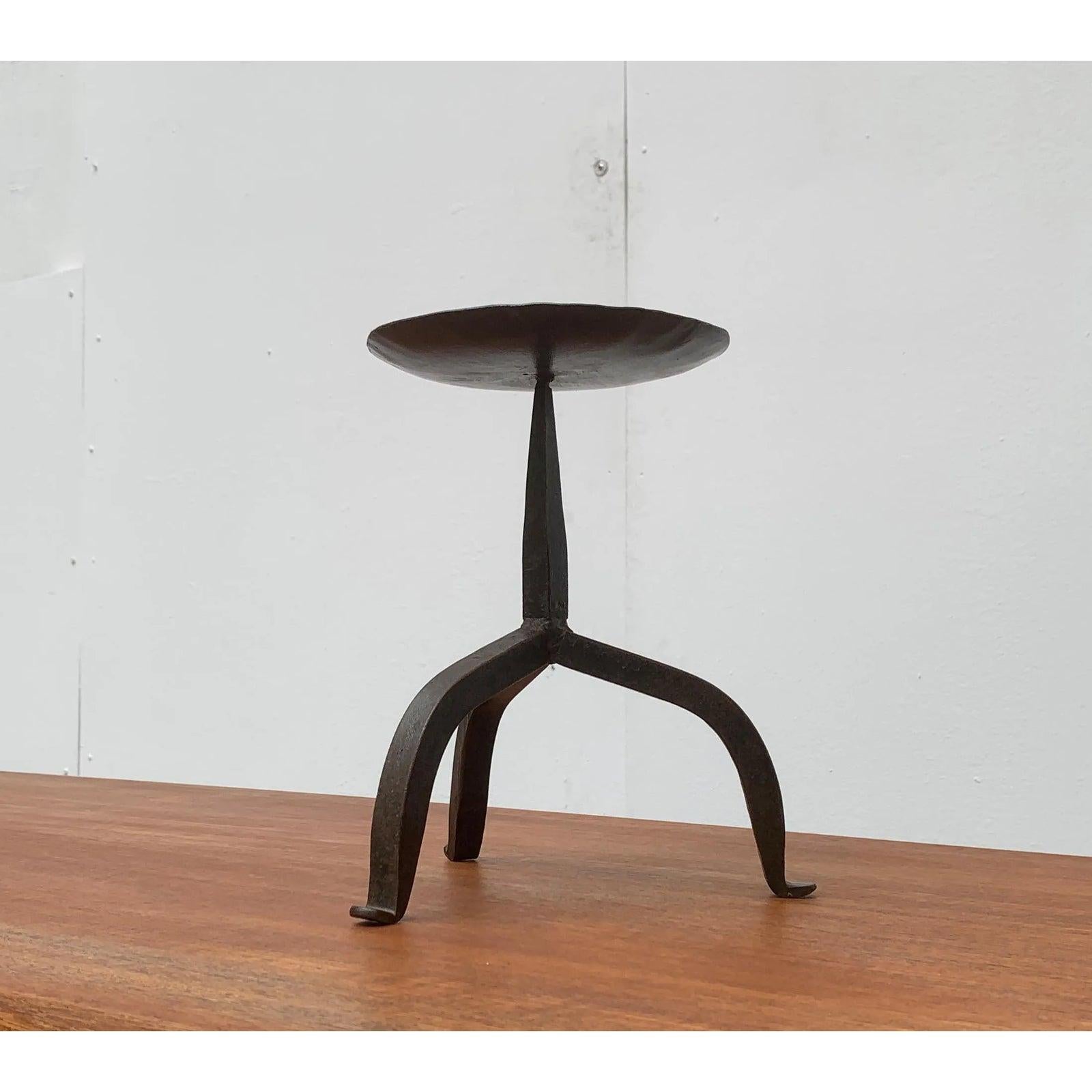 Brutalist tripod candle holder handmade from wrought iron.

Additional information:
Materials: Metal
Color: Black
Styles: Brutalist, Mid-Century Modern
Period: 1960s
Item Type: Vintage, Antique or Pre-owned
Dimensions: 8.27ʺW × 8.27ʺD ×