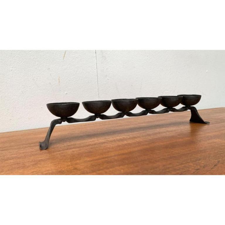 Mid-Century Brutalist Wrought Iron Candleholder, 1960s, in Very Good conditions. Designed 1960 to 1969

Additional information:
Color: Black
Styles: Brutalist, Mid-Century Modern
Item Type: Vintage, Antique or Pre-owned
Dimensions: 19.69ʺW × 2.76ʺD