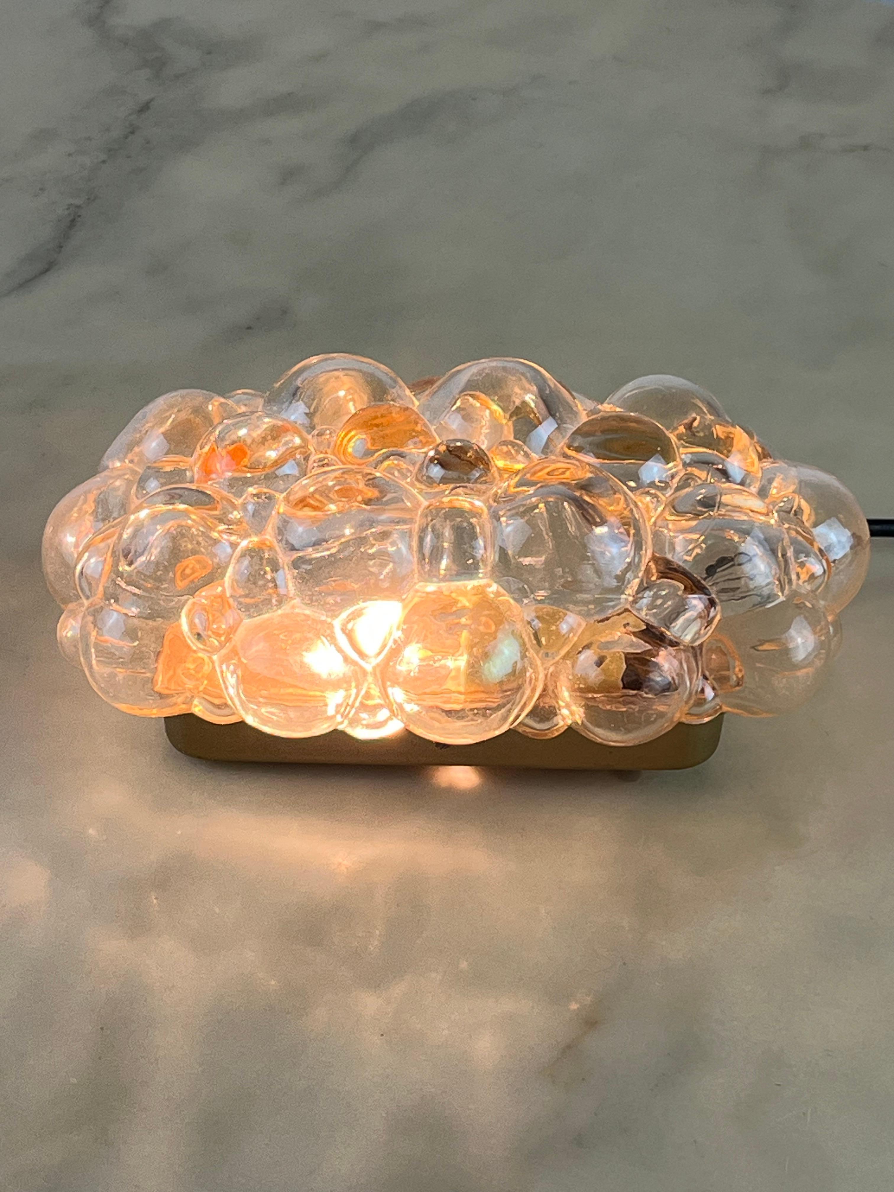 Mid-Century Bubble Glass Wall Lamp by Helena Tynell for Limburg, 1960s.
Intact and functional, golden metal structure. Measurement of the structure: 15.5 cm x 7.5 cm.
E14 lamp.
Good condition, small signs of aging.