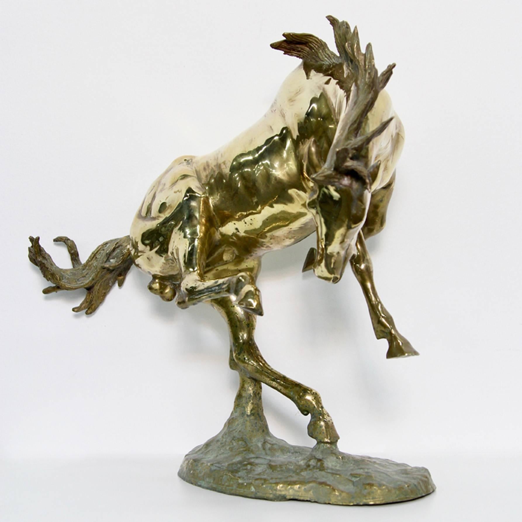 A fantastic bucking bronco done in gold brass. A showpiece perfect for any home.