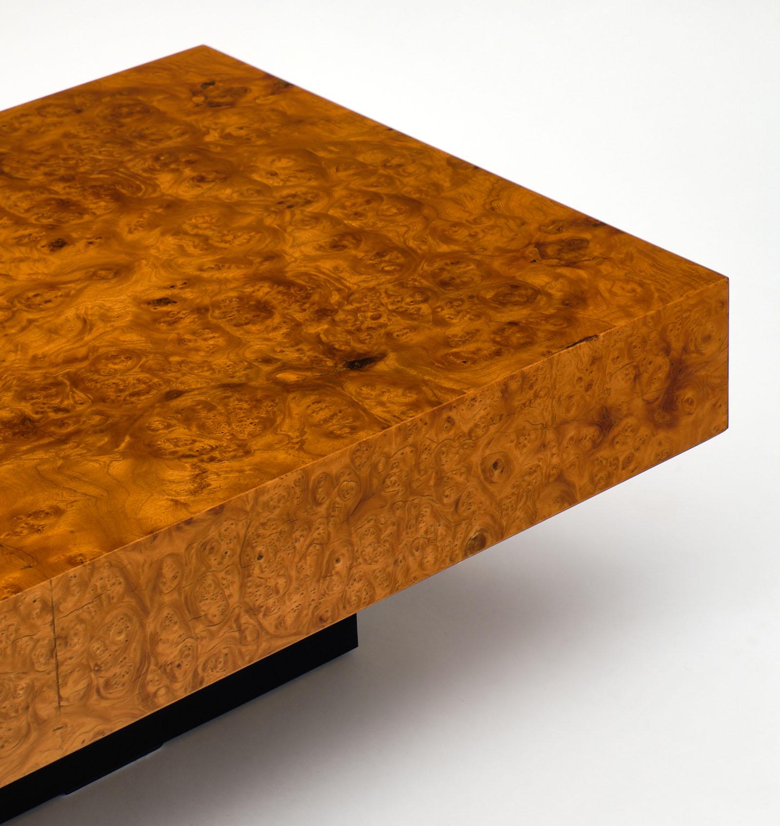 A fine French burl ash midcentury coffee table. This vintage piece has a black lacquered wood base and burled ash top. There are some minor, stabile cracks in the vinyl.