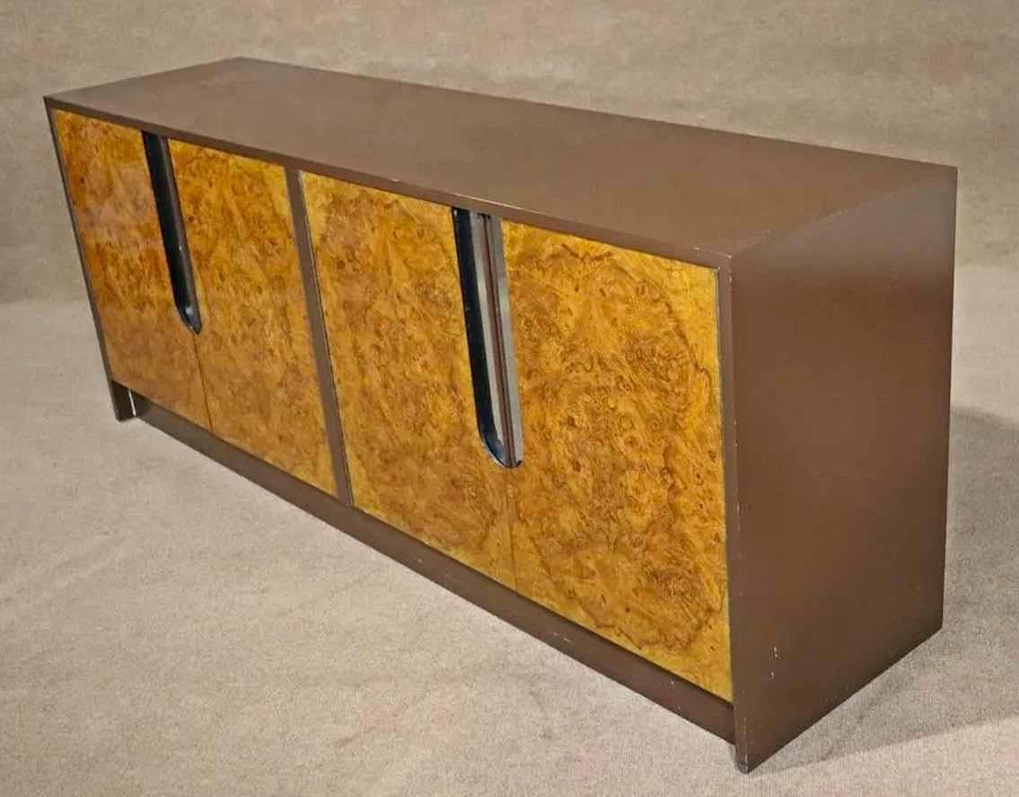 Mid-Century Modern cabinet with brilliant burl wood doors. Brown lacquer frame with polished chrome accents.
Please confirm location.