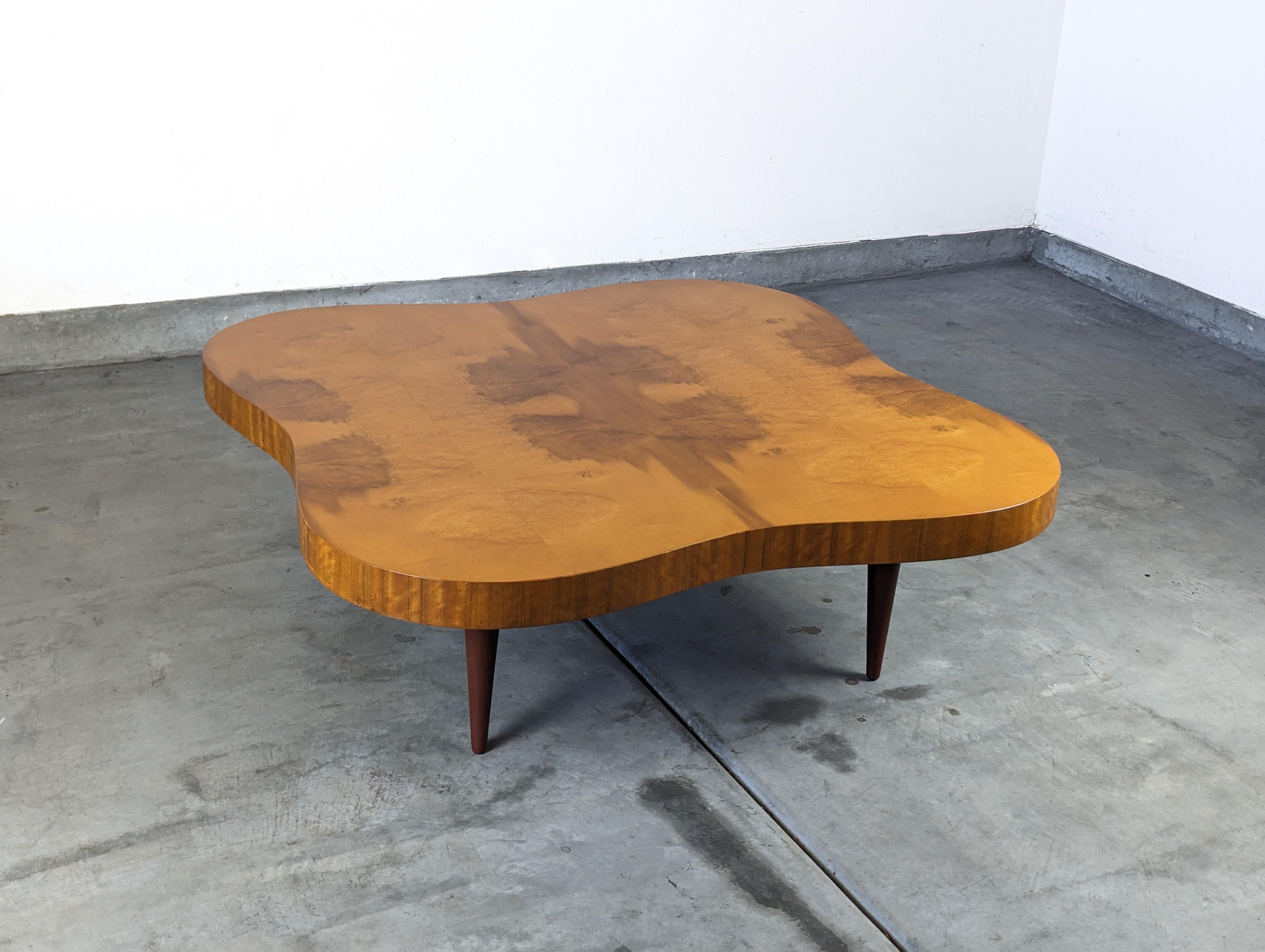 Experience the timeless charm and sophistication of mid-century modern design with this authentic Paldao coffee table, masterfully designed by the renowned Gilbert Rohde for Herman Miller in the 1940s. This is an exceptional opportunity to own a