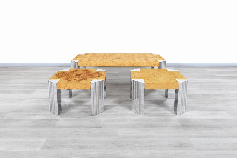 Wonderful vintage burl wood and chrome “Skyscraper” coffee table and side tables inspired in the style of Milo Baughman and manufactured in the United States, circa 1970s. These tables have a minimalist design and stand out for the fine materials