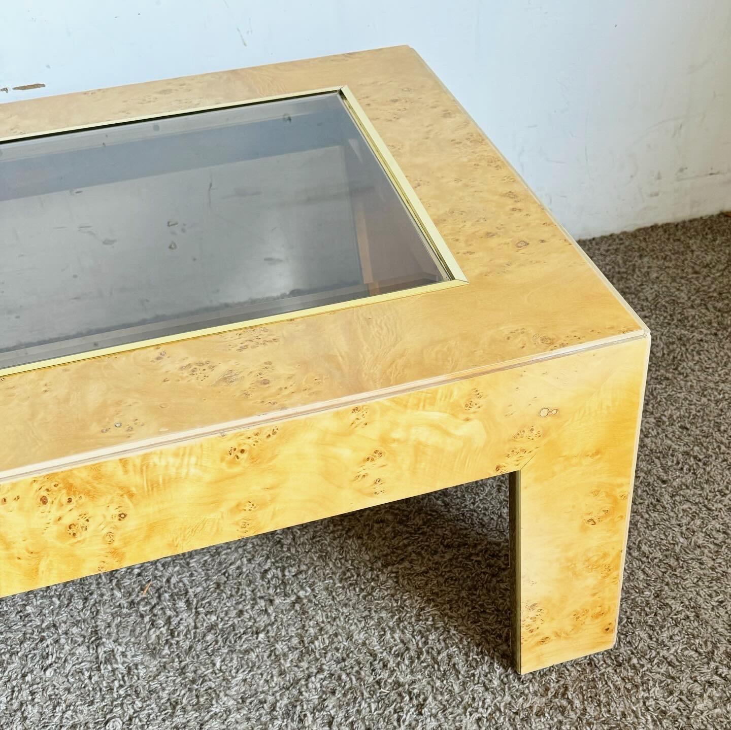 Experience the sophistication of the Thomasville Mid Century Modern Coffee Table, where Burl wood veneer meets smoked glass and gold accents. This piece embodies mid-century elegance, featuring rich textures and a sleek, contemporary feel. The Burl