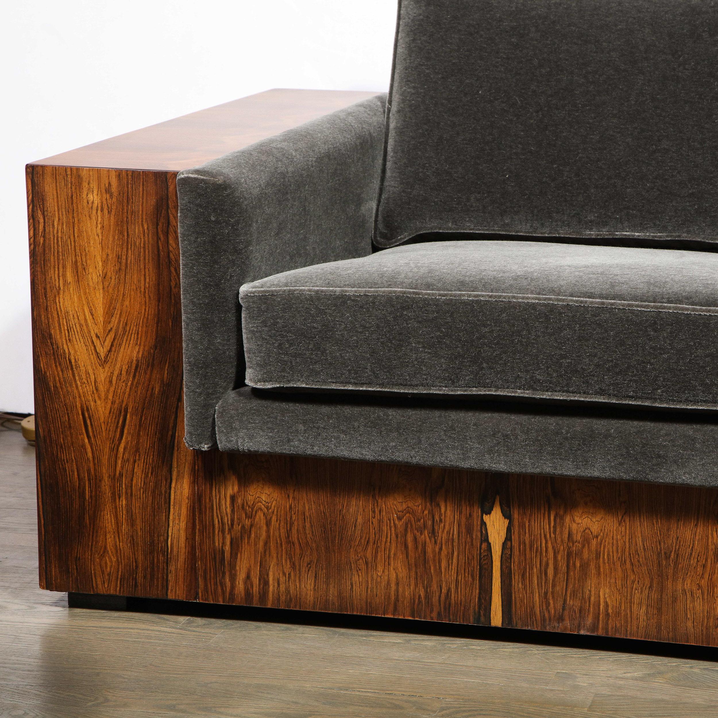 This elegant and understated sofa was designed by Milo Baughman and realized by Thayer Coggin in the United States, circa 1970. It features an austere rectilinear form with two rectangular arms that provide ample space to support a drink glass