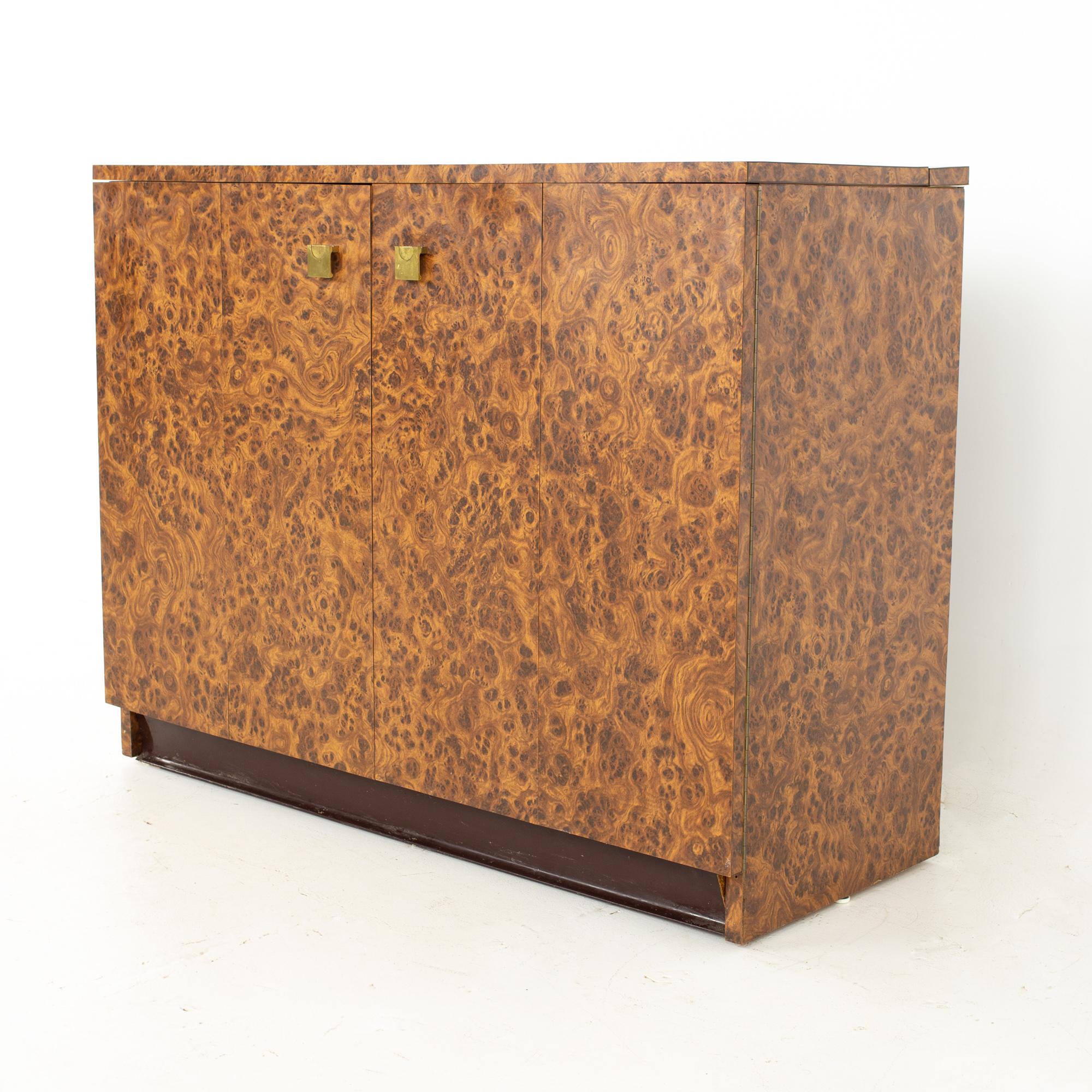 Mid century burlwood laminate and brass bar record credenza.
Credenza measures: 42.75 wide x 17.5 deep x 33 inches high

All pieces of furniture can be had in what we call restored vintage condition. That means the piece is restored upon purchase